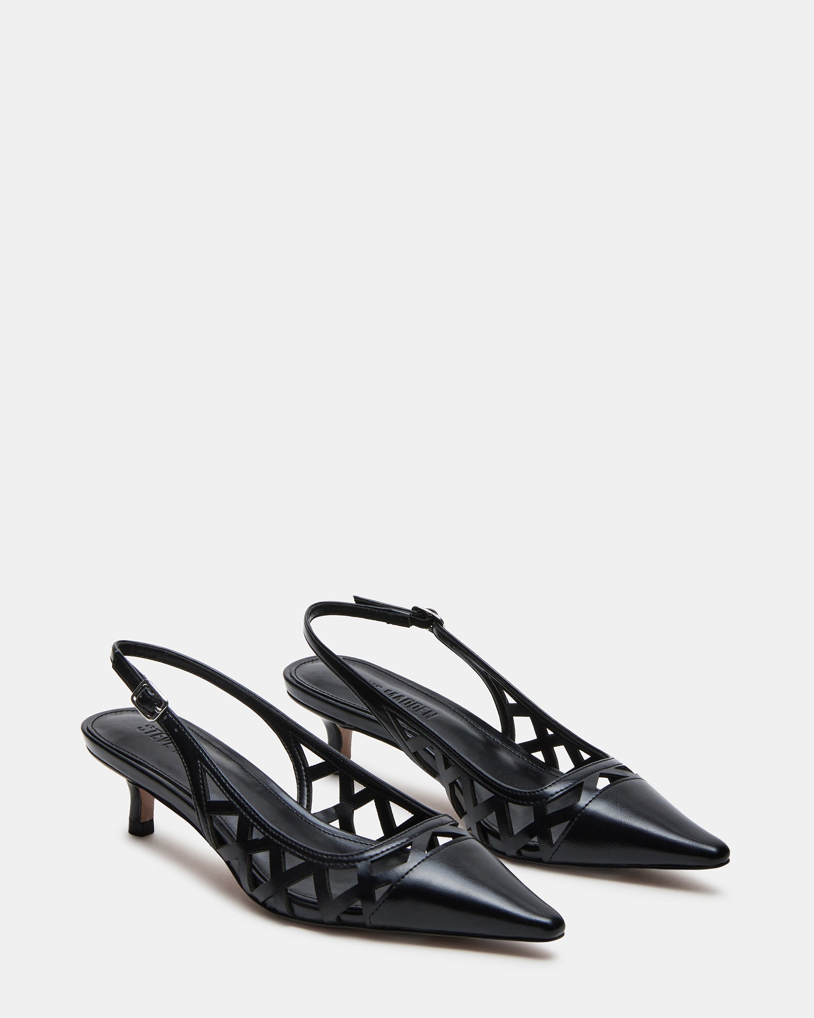 Side view of black slingbacks worn on Chicago sidewalk for office style