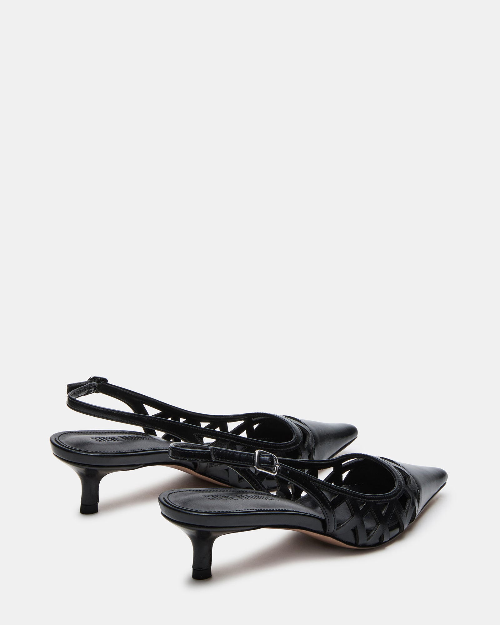 Side view of black slingbacks worn on Chicago sidewalk for office style