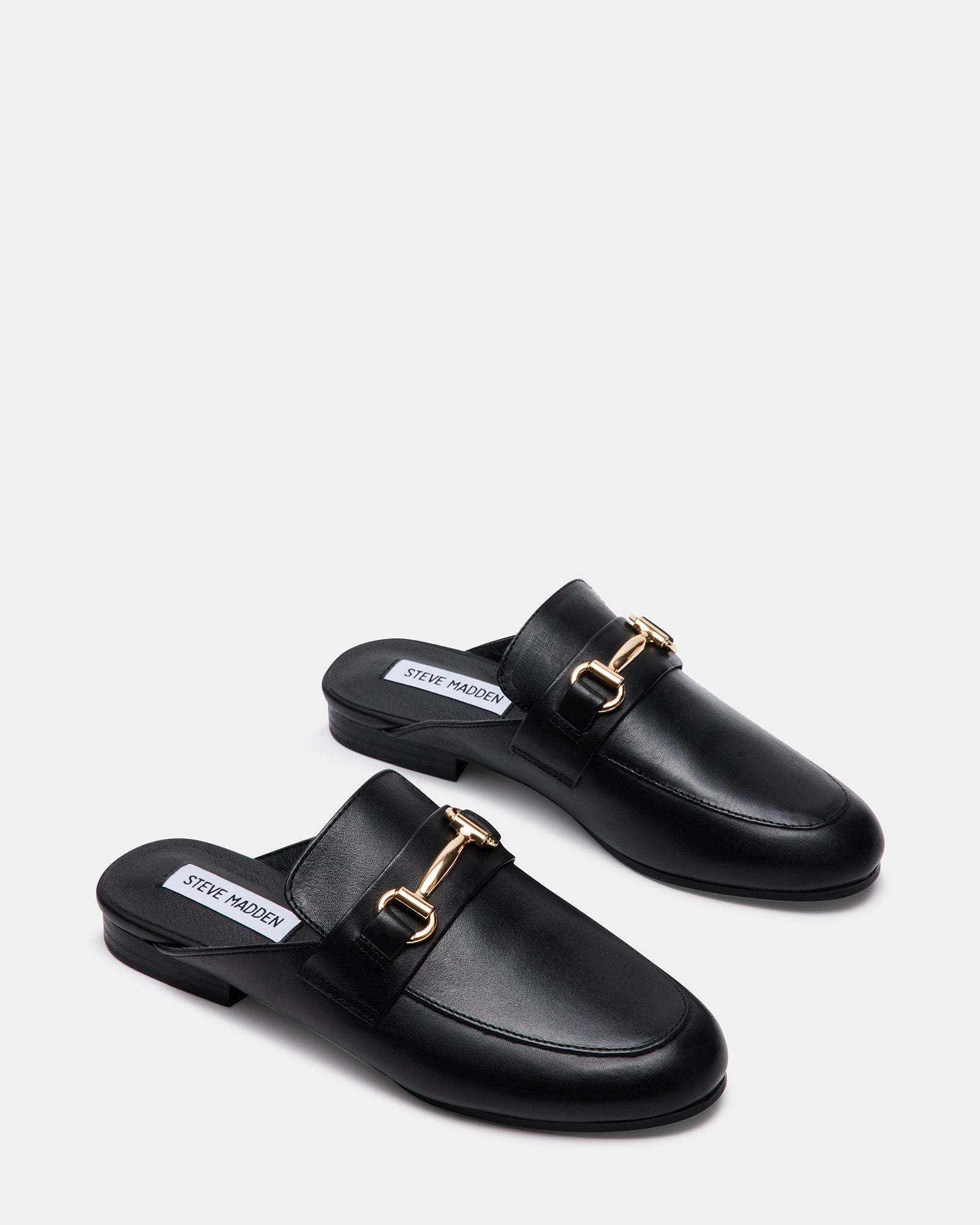 Close-up of the horse bit ornament on Kandi Luxe loafers.