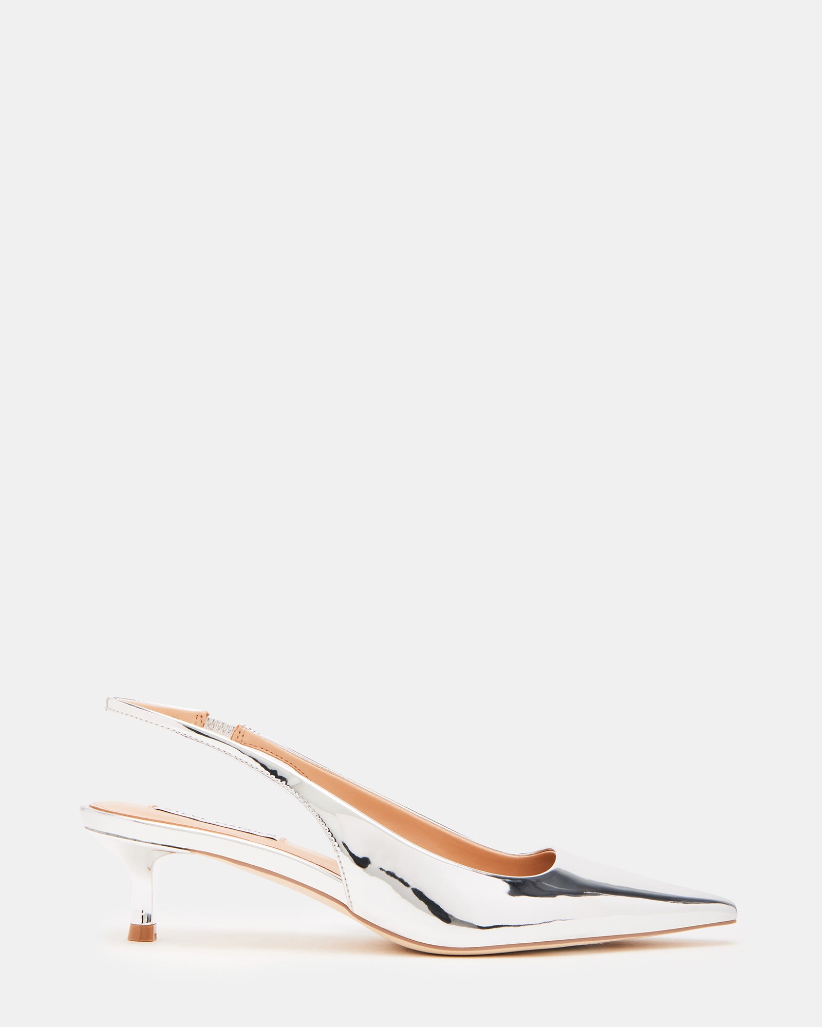 Side view of Kari silver slingback kitten heels with pointed toe detail on model outdoors