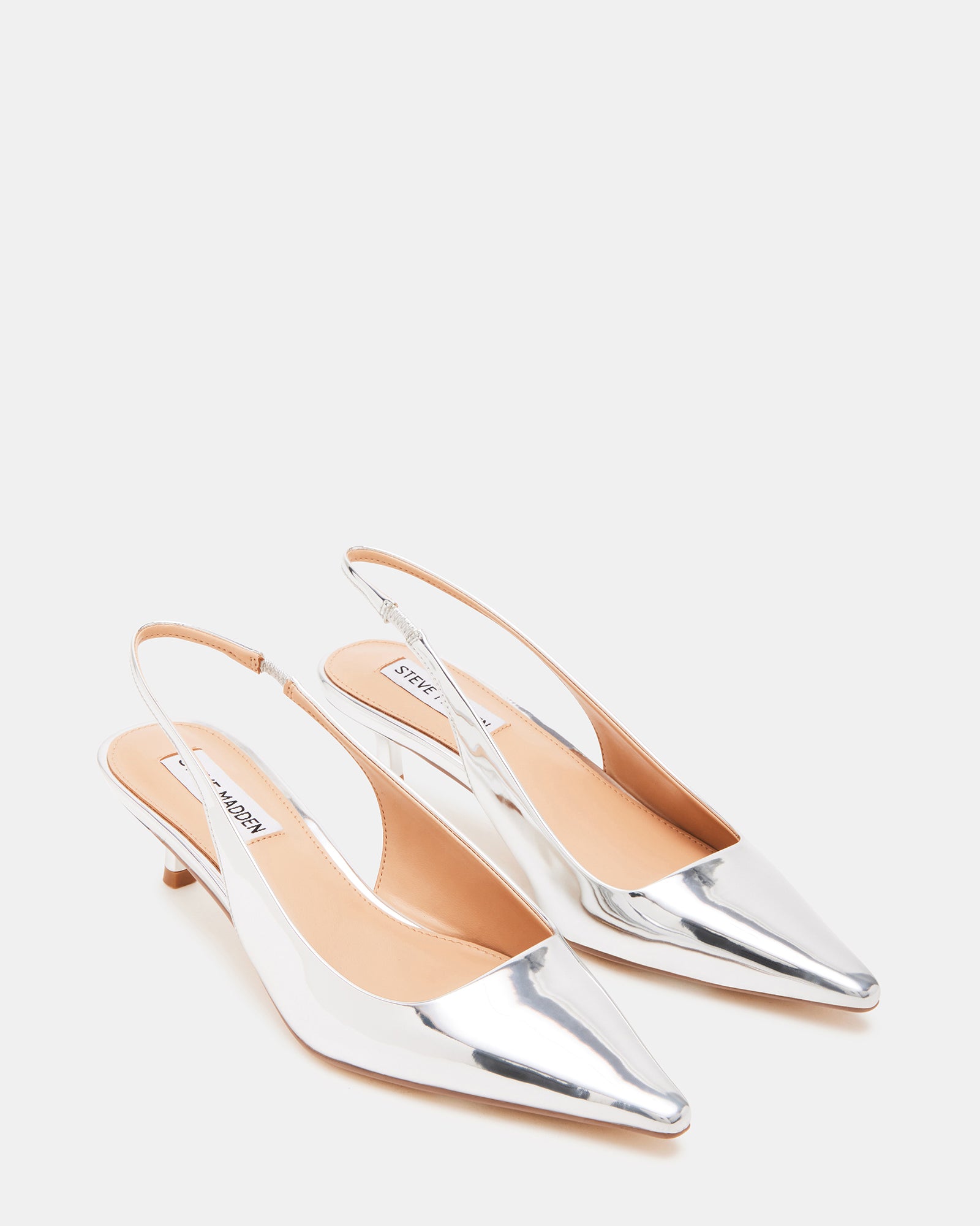 Flat lay of womens mule shoes, slingback kitten heels arranged for styling inspiration