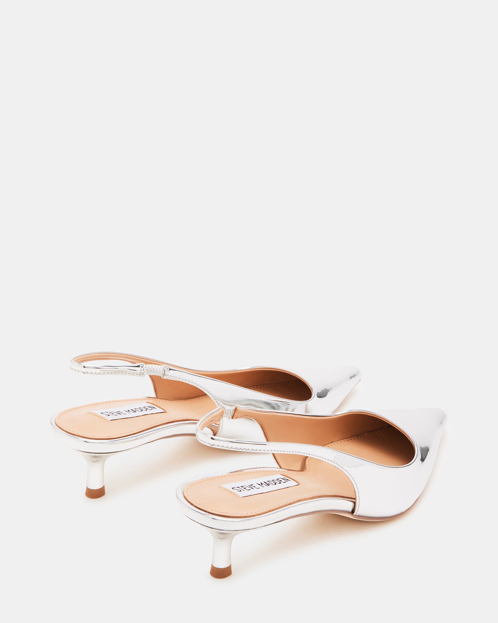 Flat lay of womens mule shoes, slingback kitten heels arranged for styling inspiration