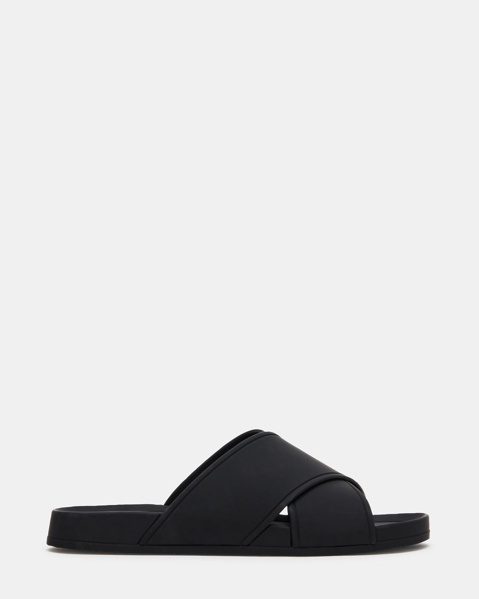 Side view of KATELYN black slide sandals showcasing criss-cross design.