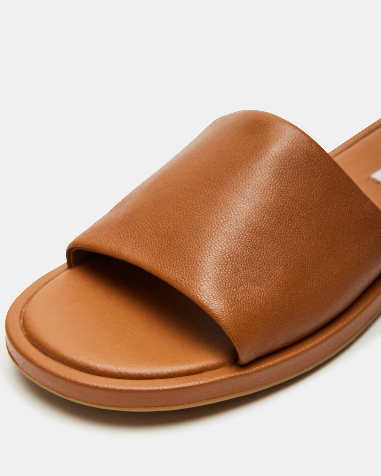 Close-up of Kaya slide sandals showcasing premium leather and sleek design.