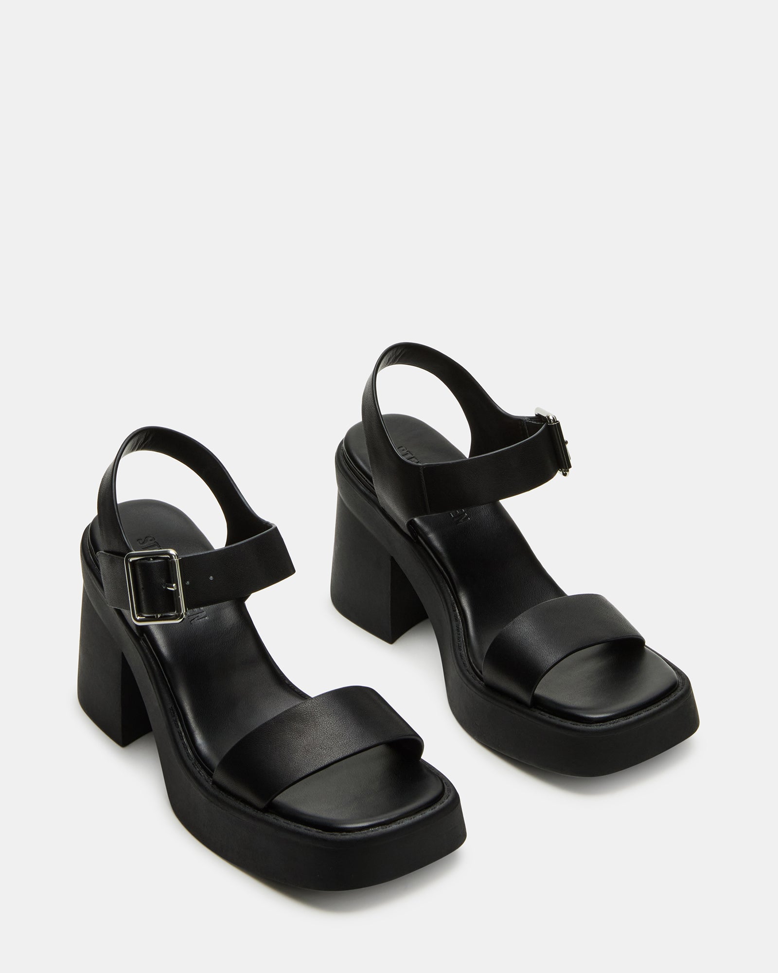 Styled outfit featuring black block heel sandals in a downtown setting