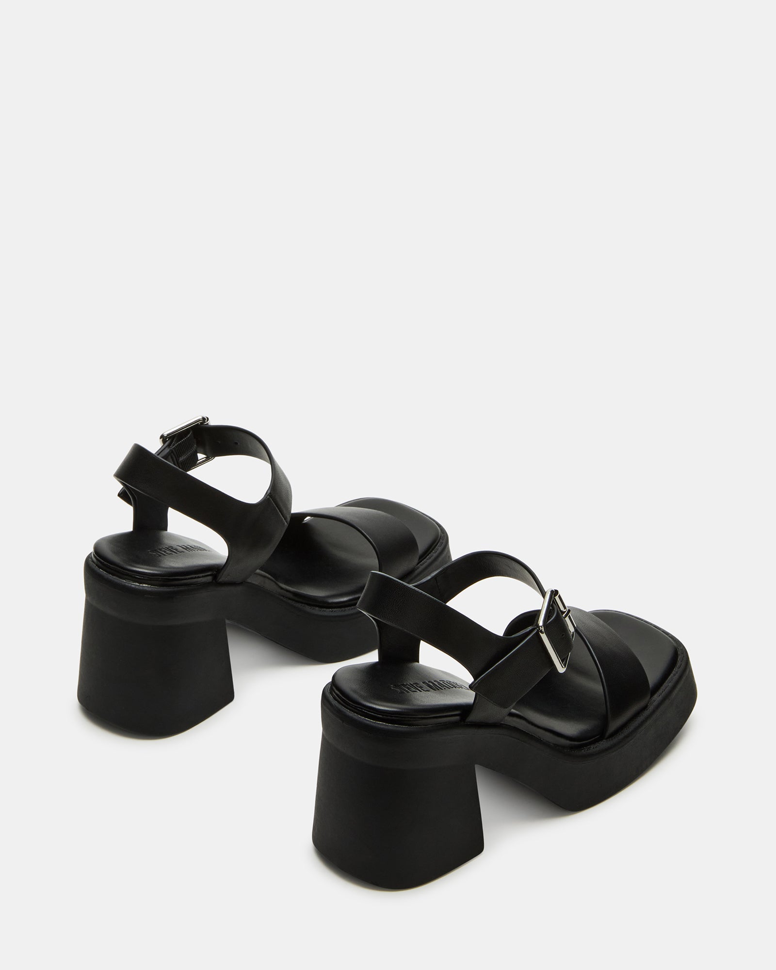 Styled outfit featuring black block heel sandals in a downtown setting