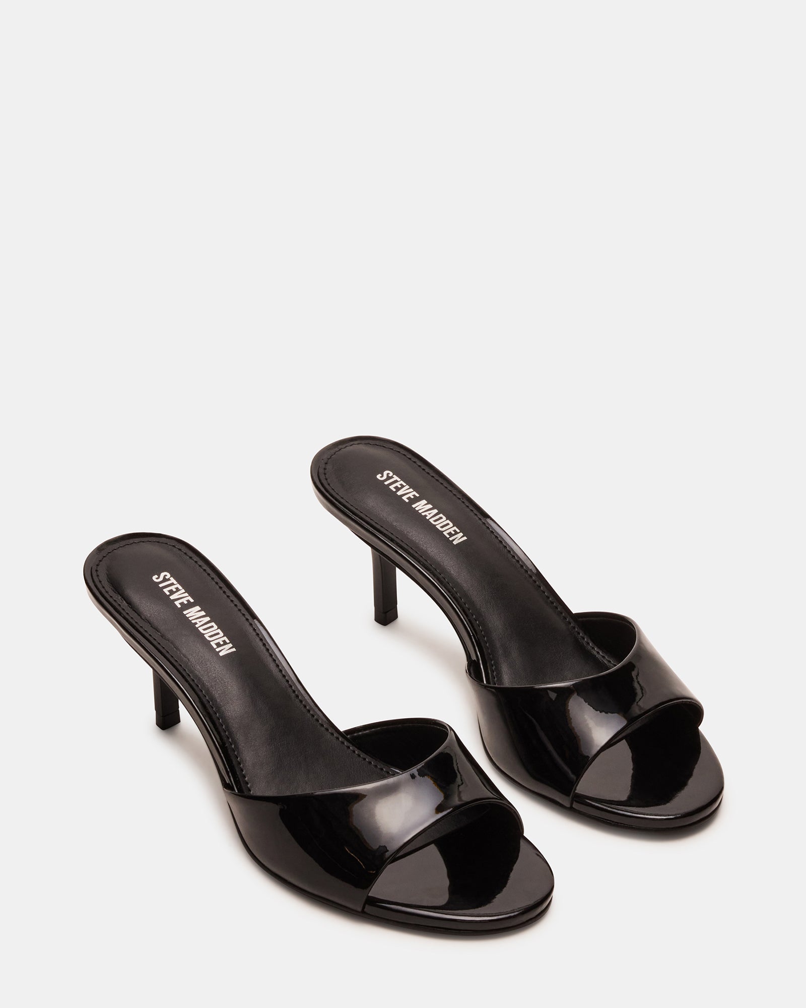 Close-up of kitten heel mules shoes with rounded toe and glossy finish