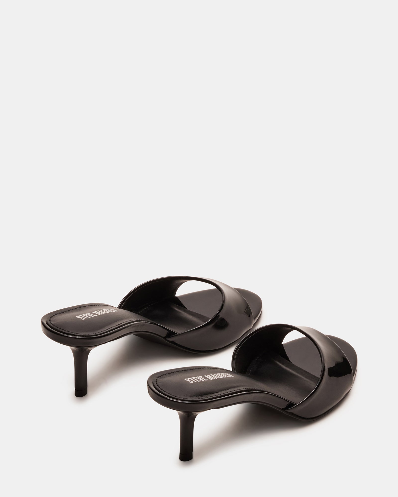 Close-up of kitten heel mules shoes with rounded toe and glossy finish