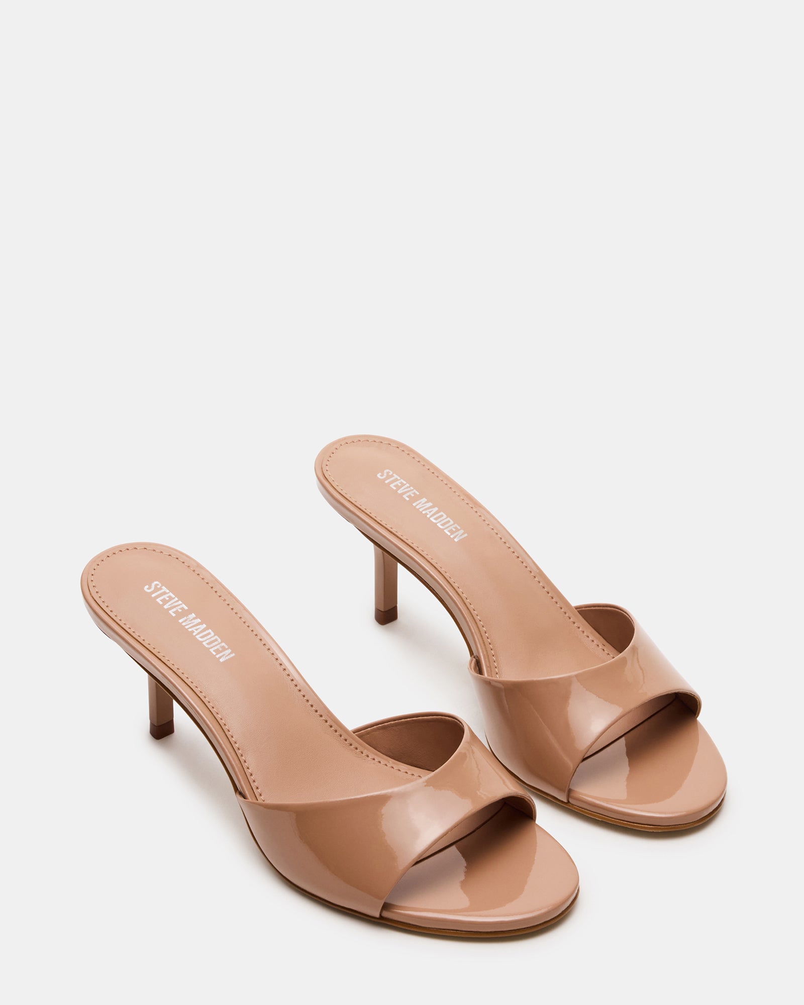 Side view of the KENDRIX blush leather kitten heel mules highlighting the sleek design.