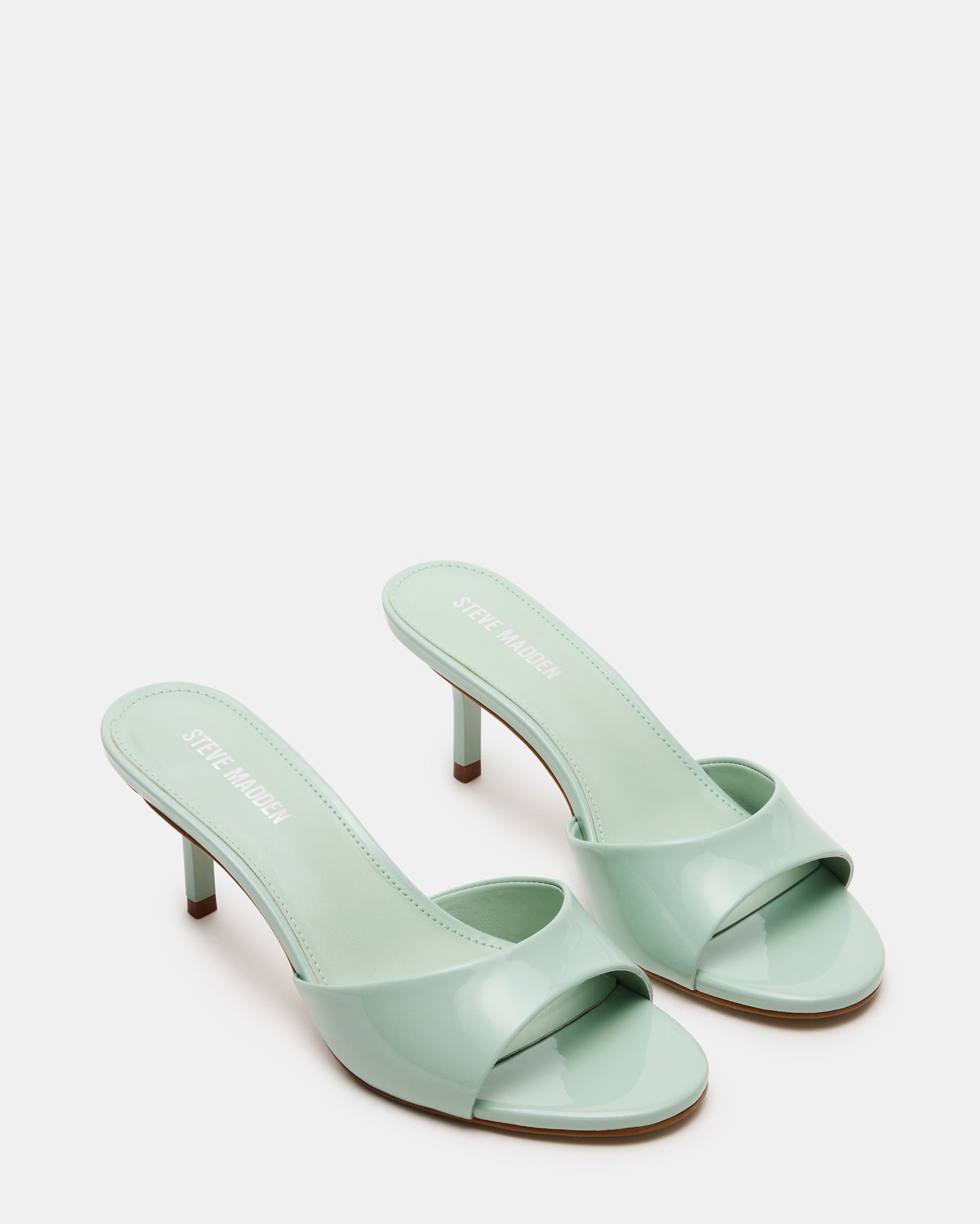 Front shot of KENDRIX mules showing rounded toe and 3-inch heel, suitable for black or white heels styles