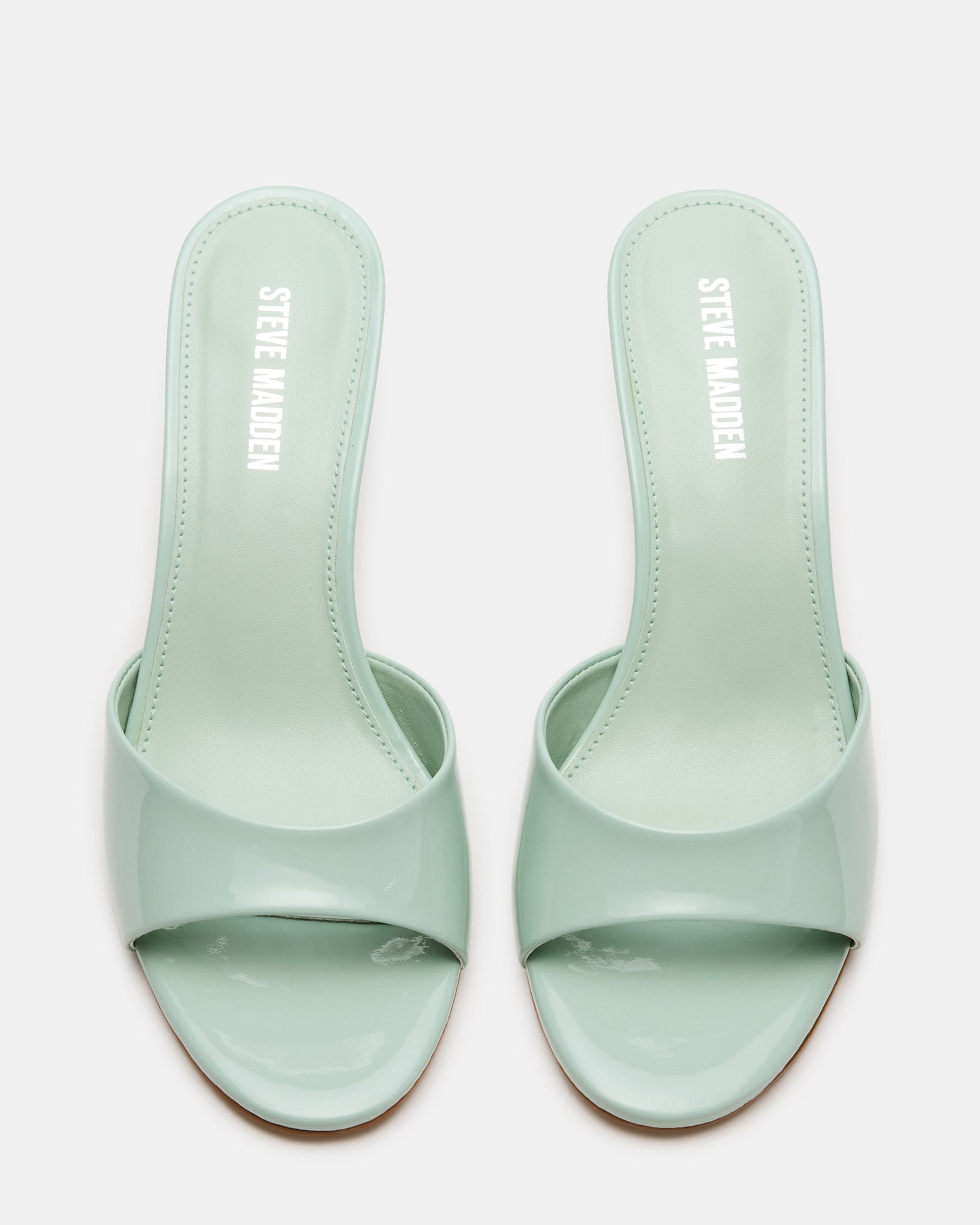 Side view of KENDRIX PISTACHIO mules with patent leather shine, ideal for women’s shoes collection