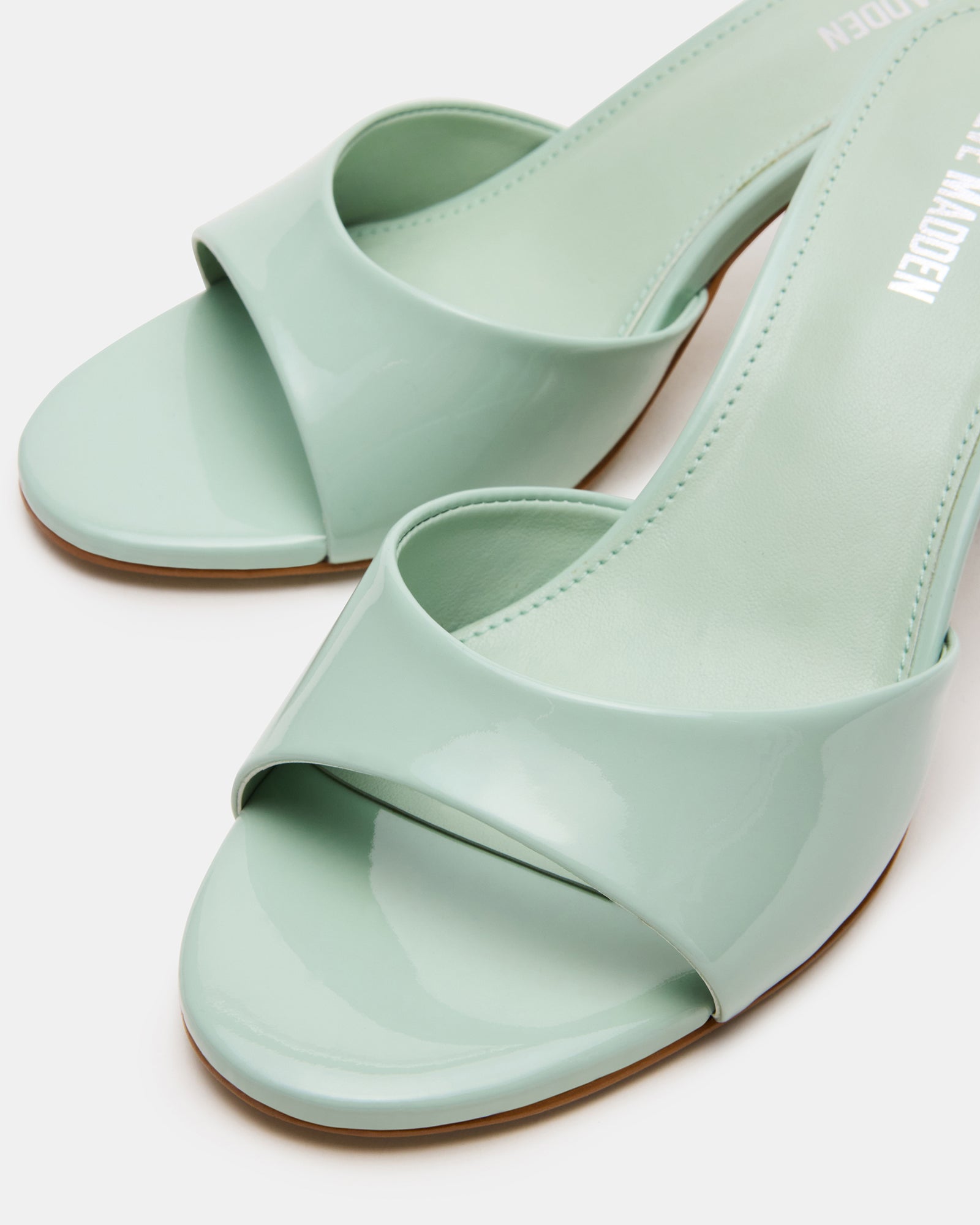 Close-up of the textured patent leather upper on KENDRIX PISTACHIO mules, perfect for elegant women’s shoes