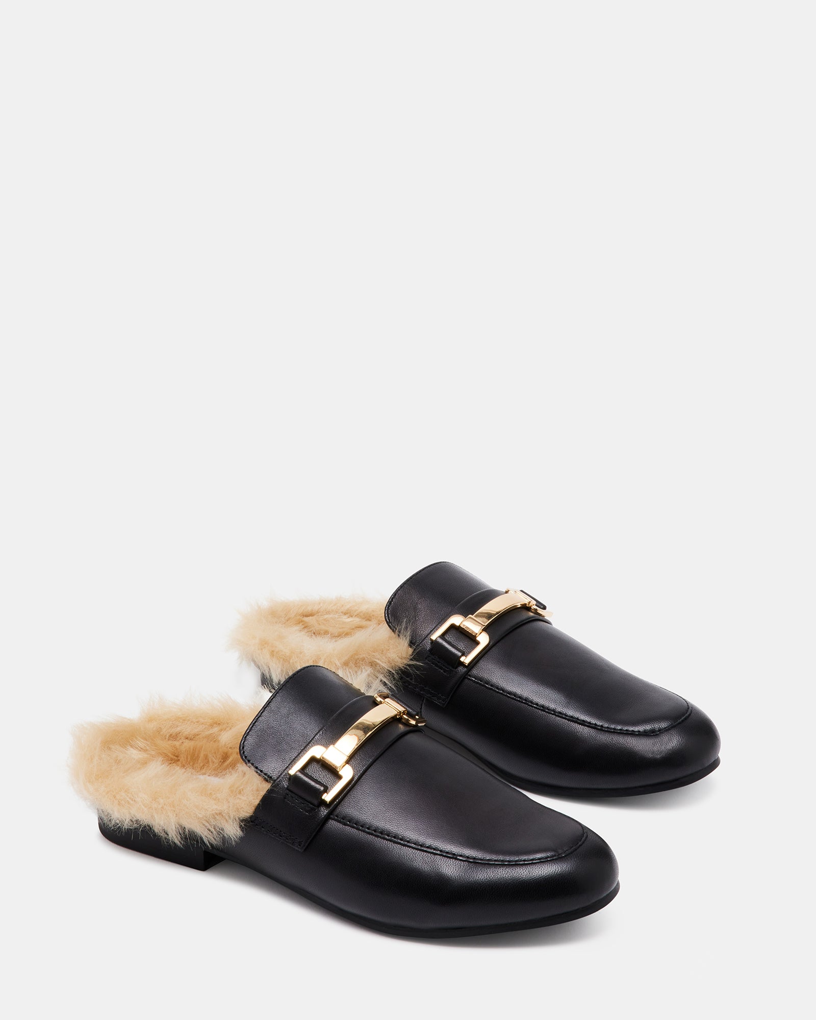 Model wearing KHLOE black leather mules in a casual outfit