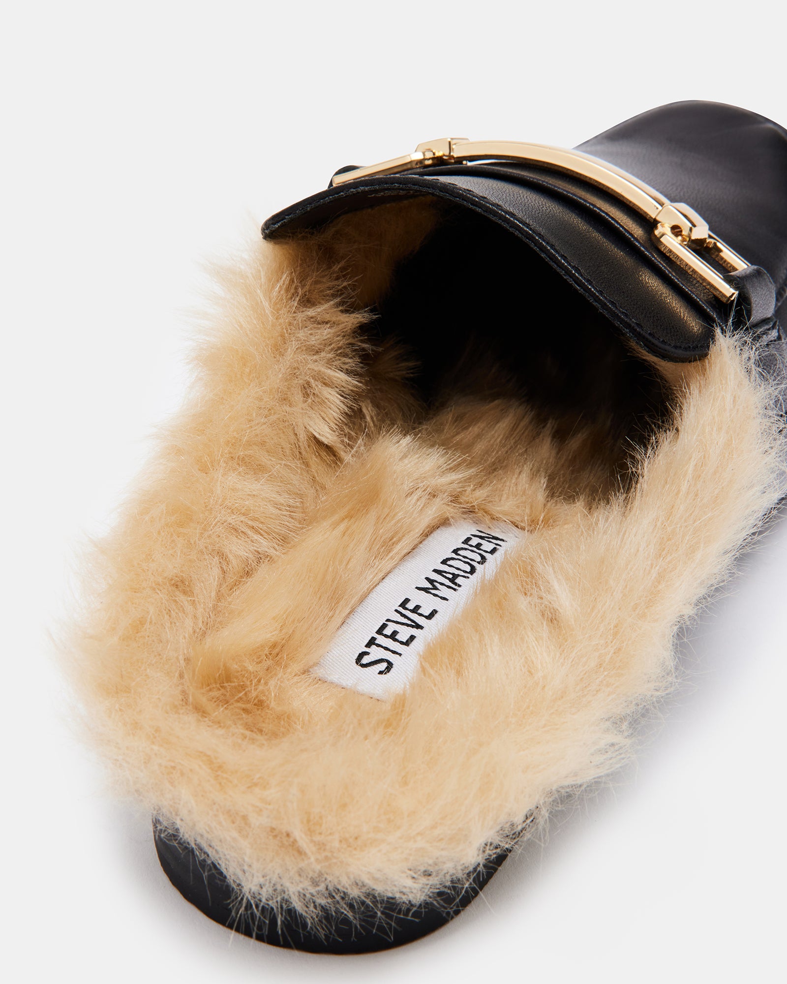 Side view of KHLOE black leather mules showcasing faux fur lining