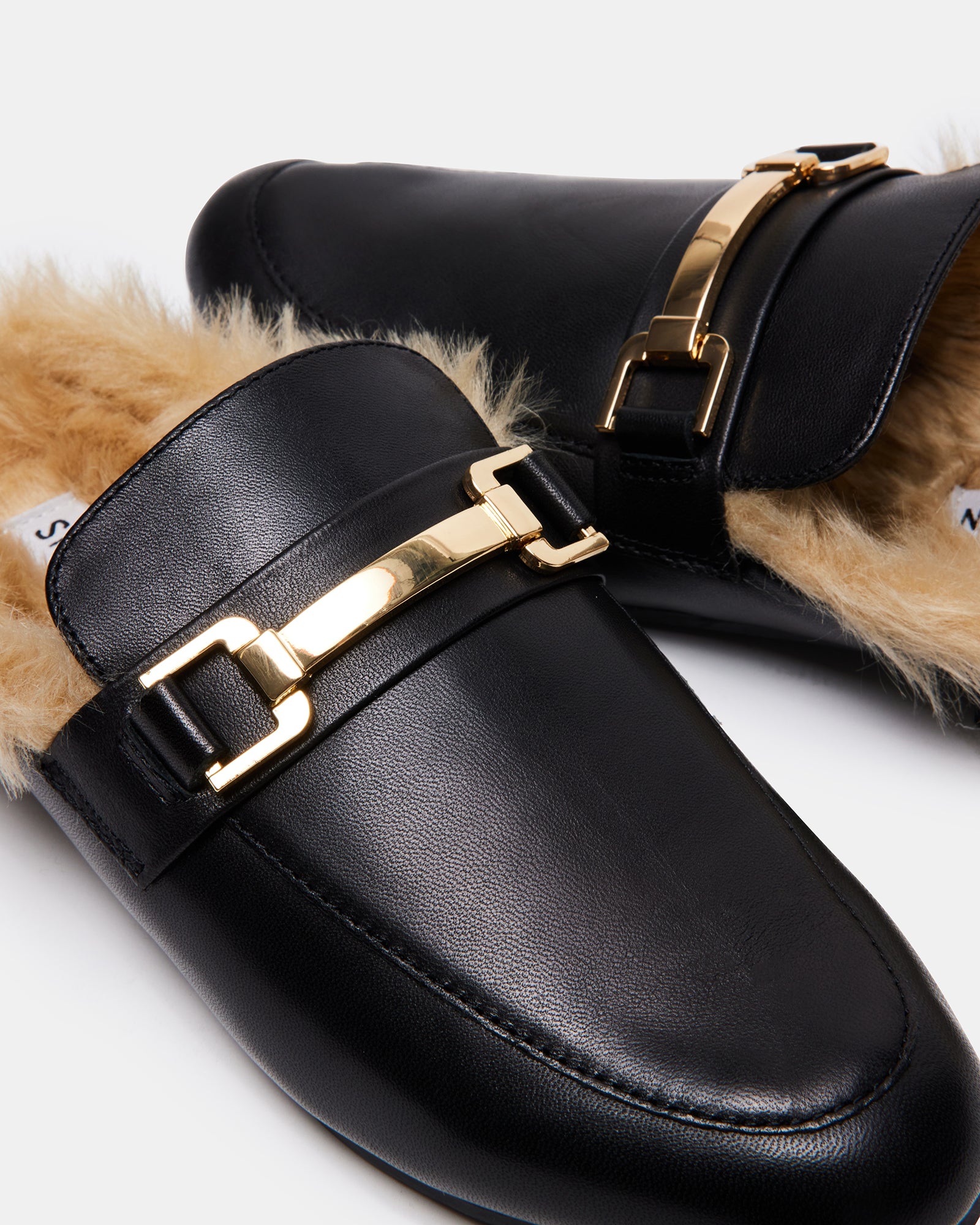 Close-up of the metallic detail on KHLOE black leather mules
