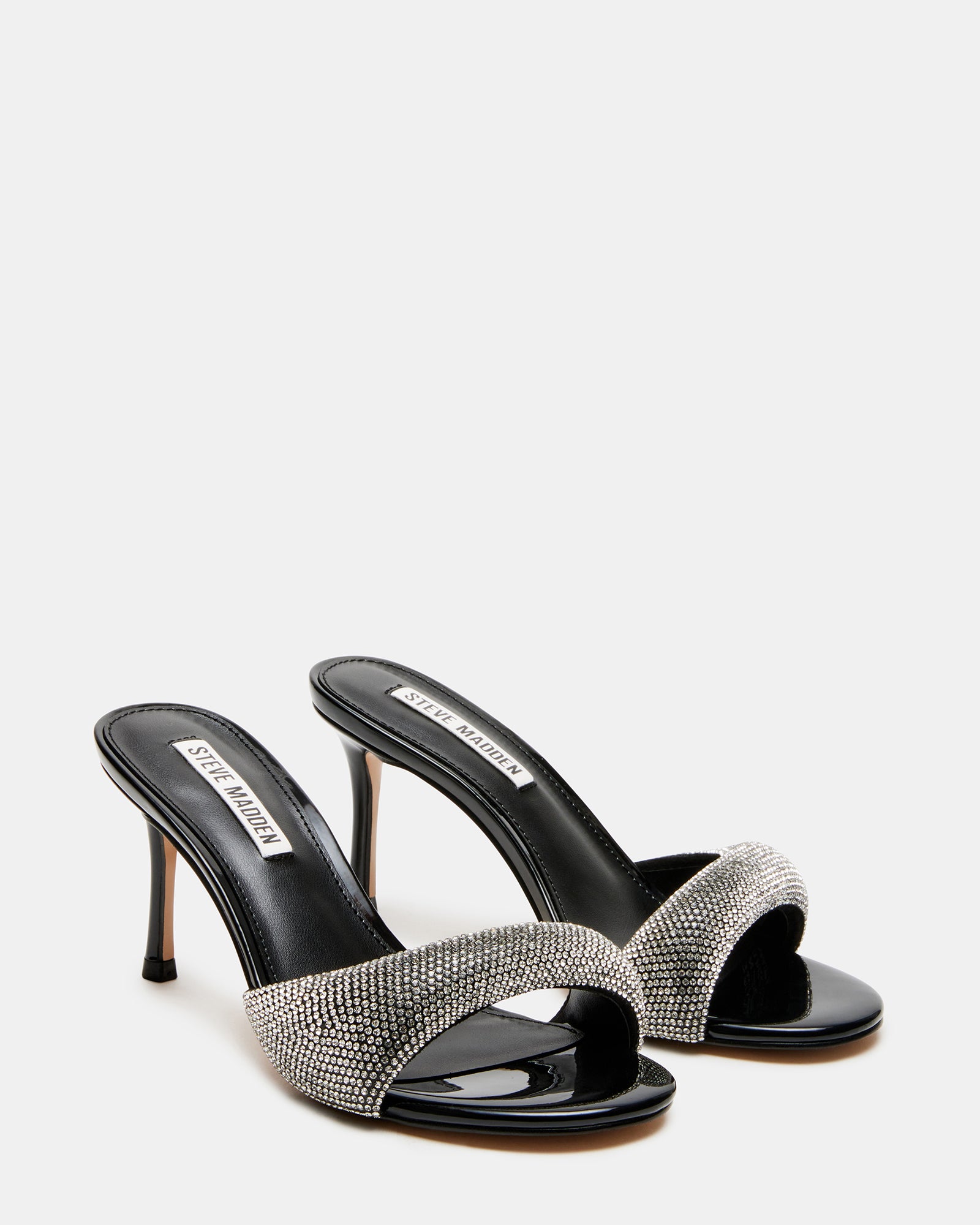Side view of the black heels paired with tailored trousers for a chic look