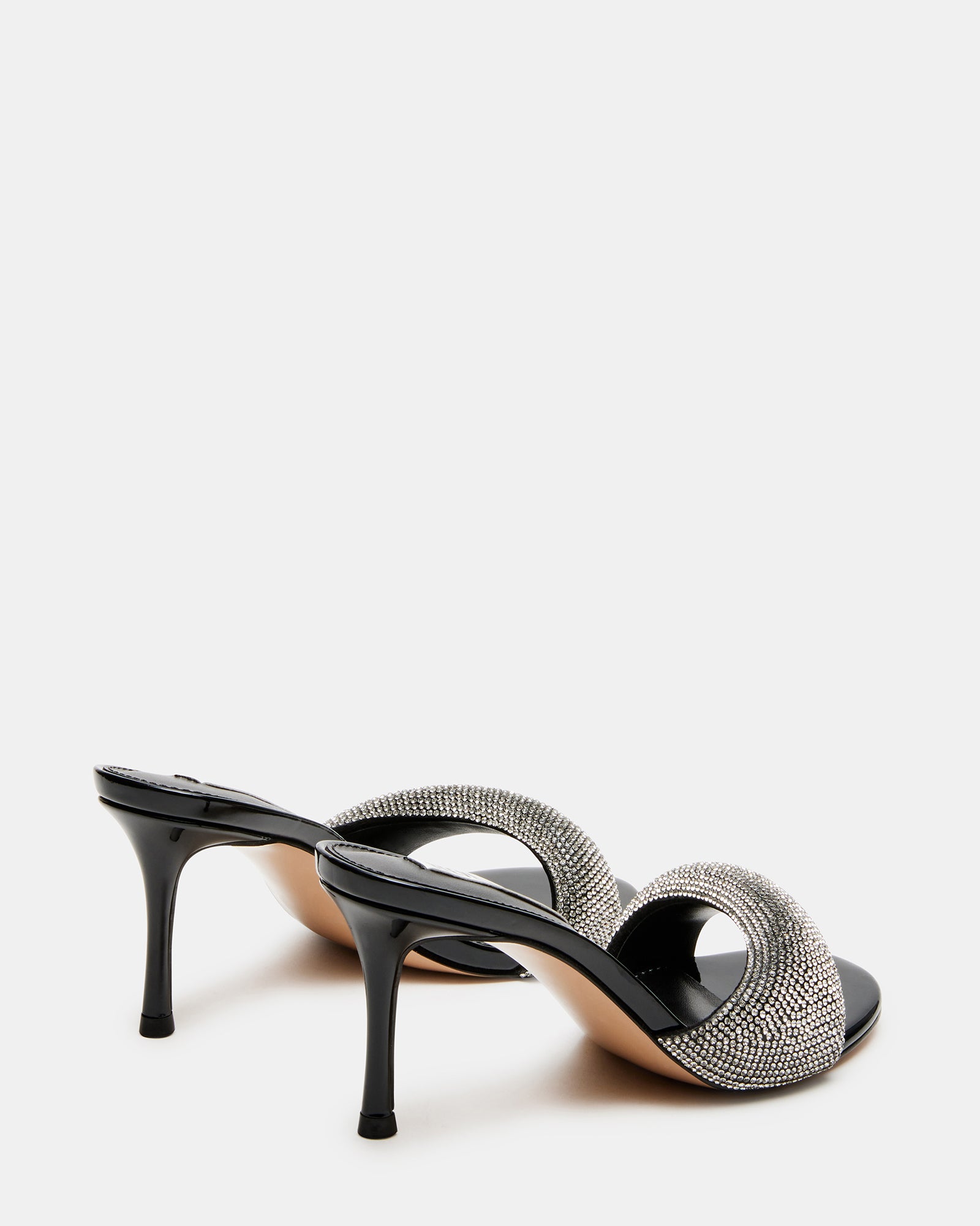 Side view of the black heels paired with tailored trousers for a chic look