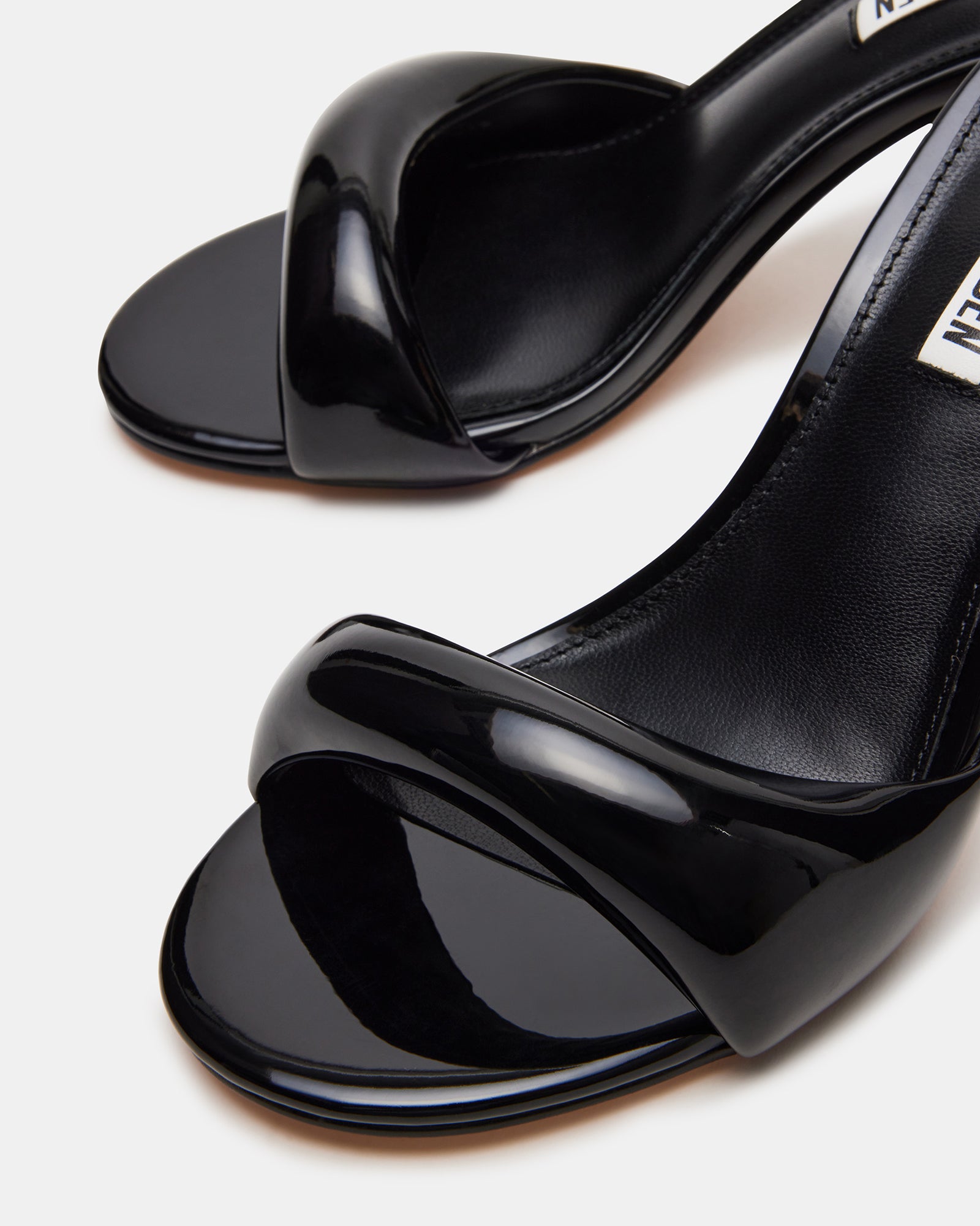 Side view of Kieran black high heel mules showcasing the bubble strap design.