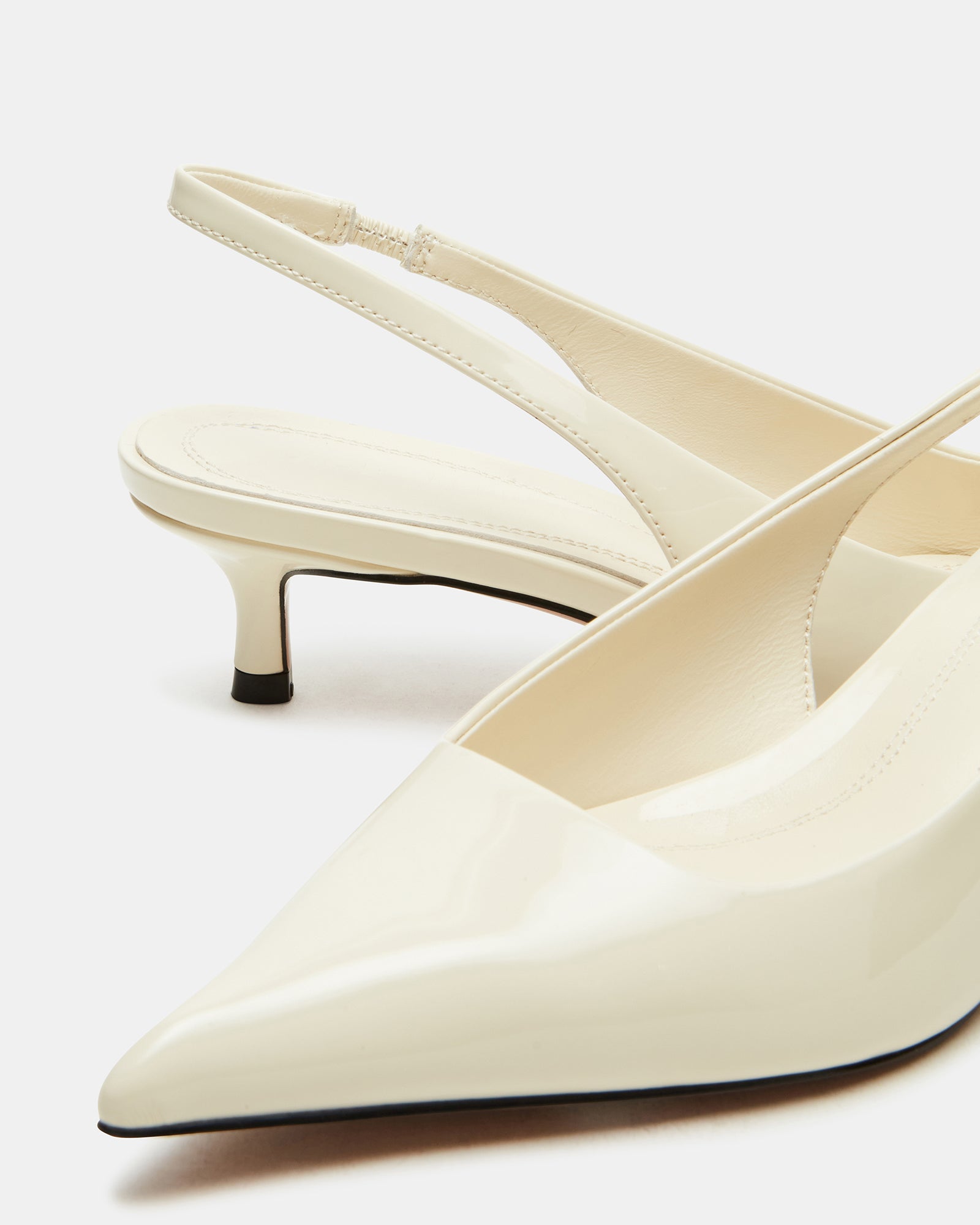 Elegant white kitten heel pumps with a slingback design