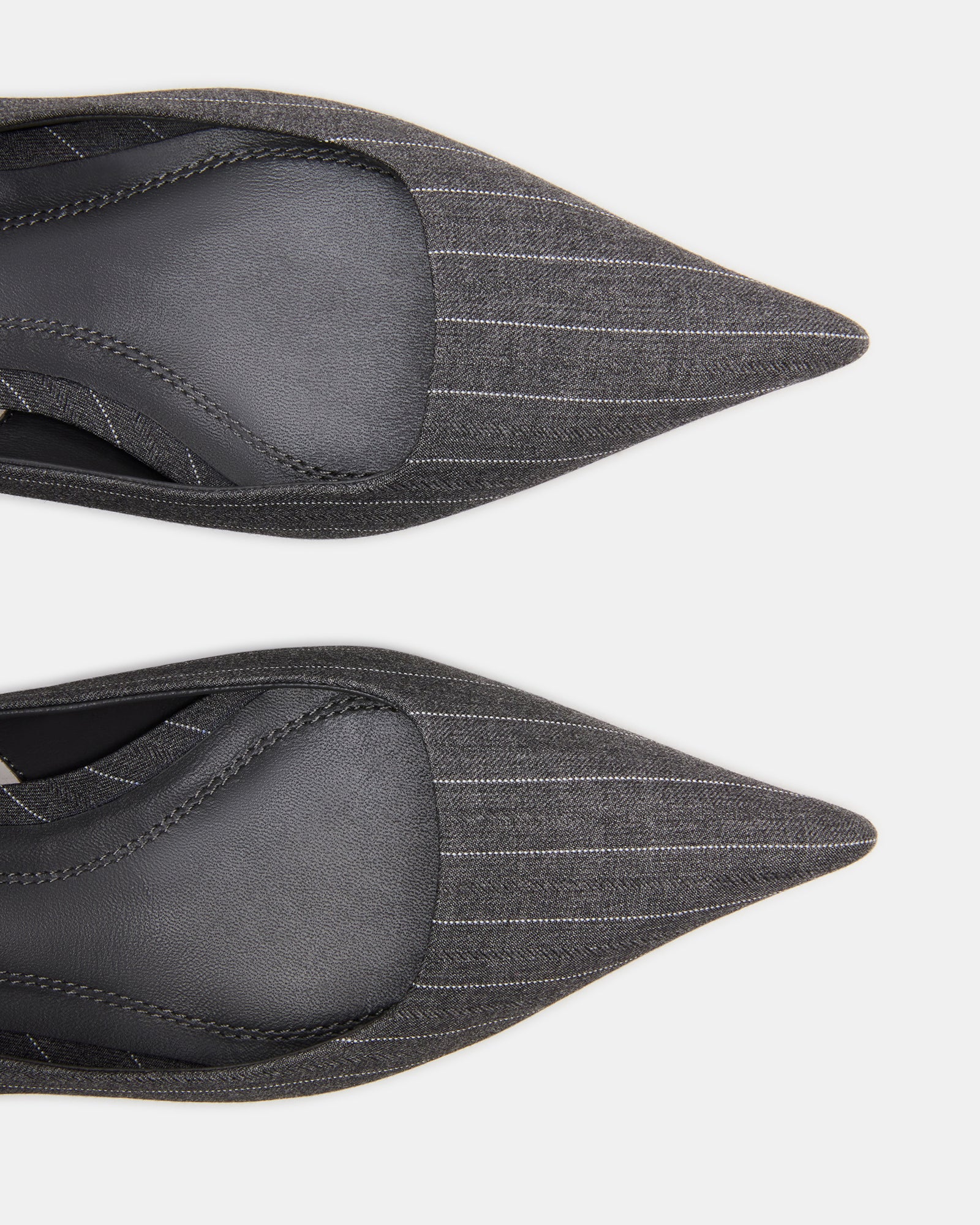 Close-up of textured textile upper on gray kitten heel pumps with leather lining