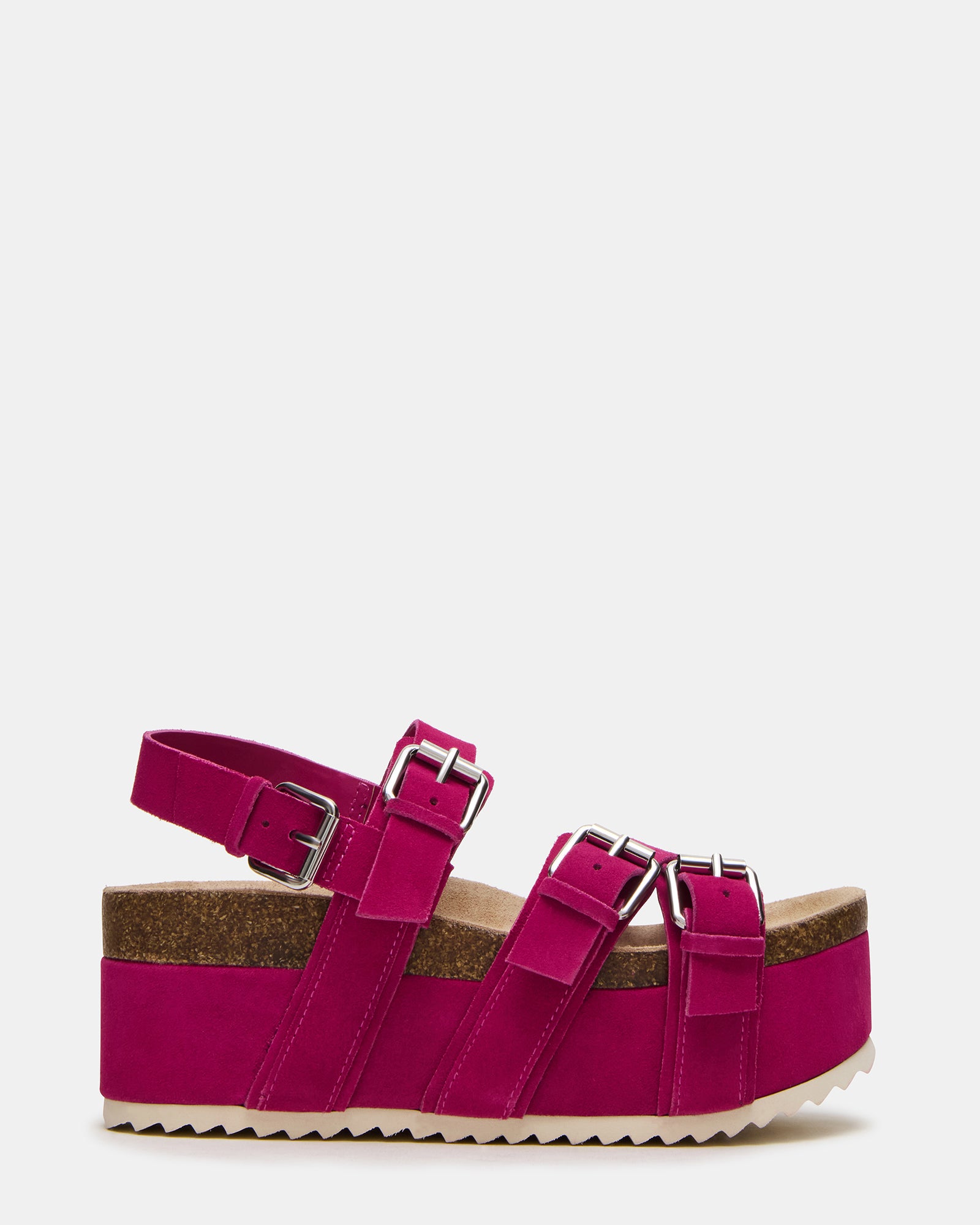 Side view of Kiwi pink suede platform sandals on a model