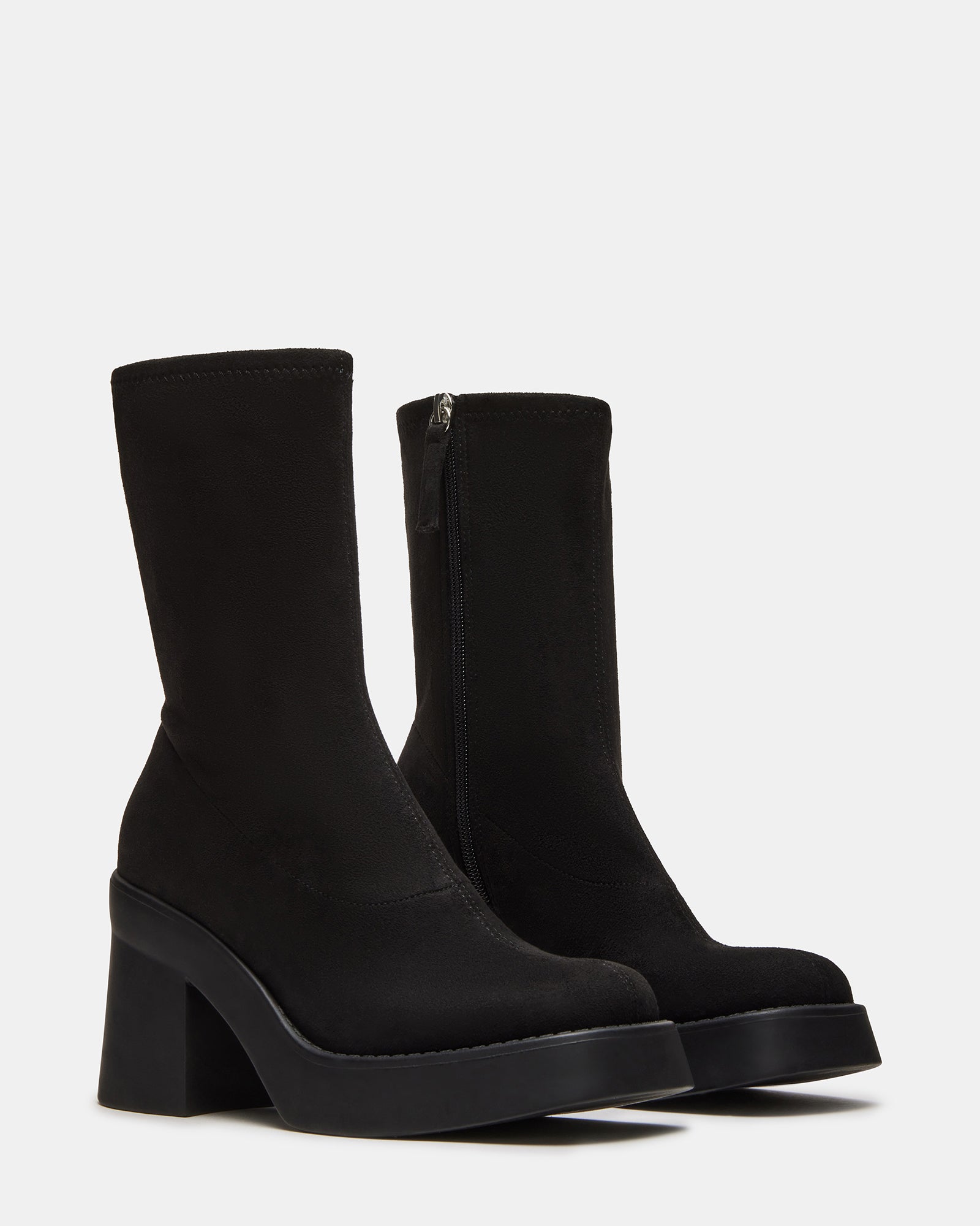 Detail of womens fashion boots mid-calf stretch fit with denim outfit