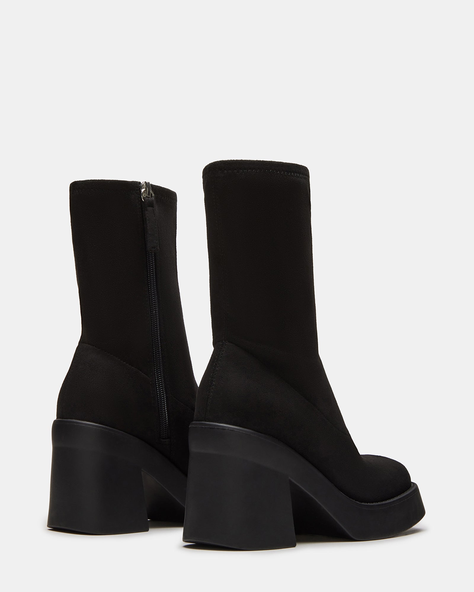 Detail of womens fashion boots mid-calf stretch fit with denim outfit