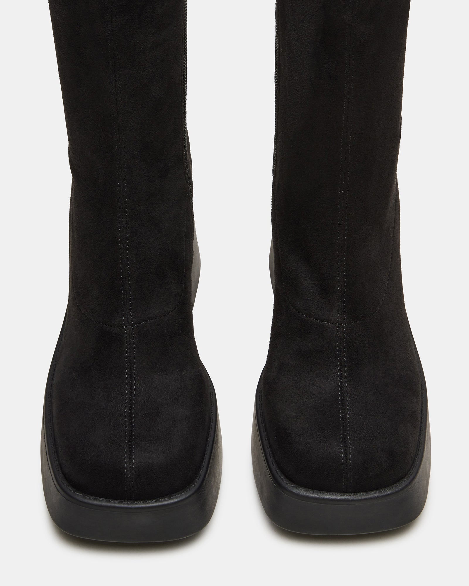 Side angle of boots platform shoes showing thick sole and microsuede texture