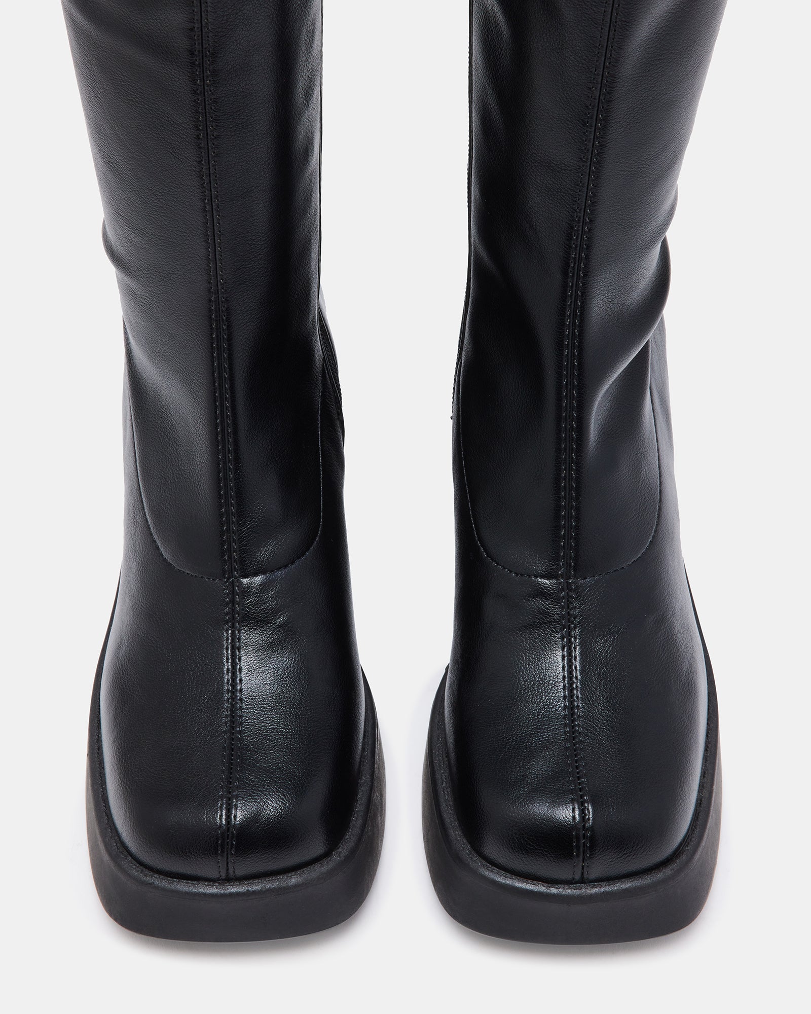 Side view of 70s inspired boots with thick white platform sole