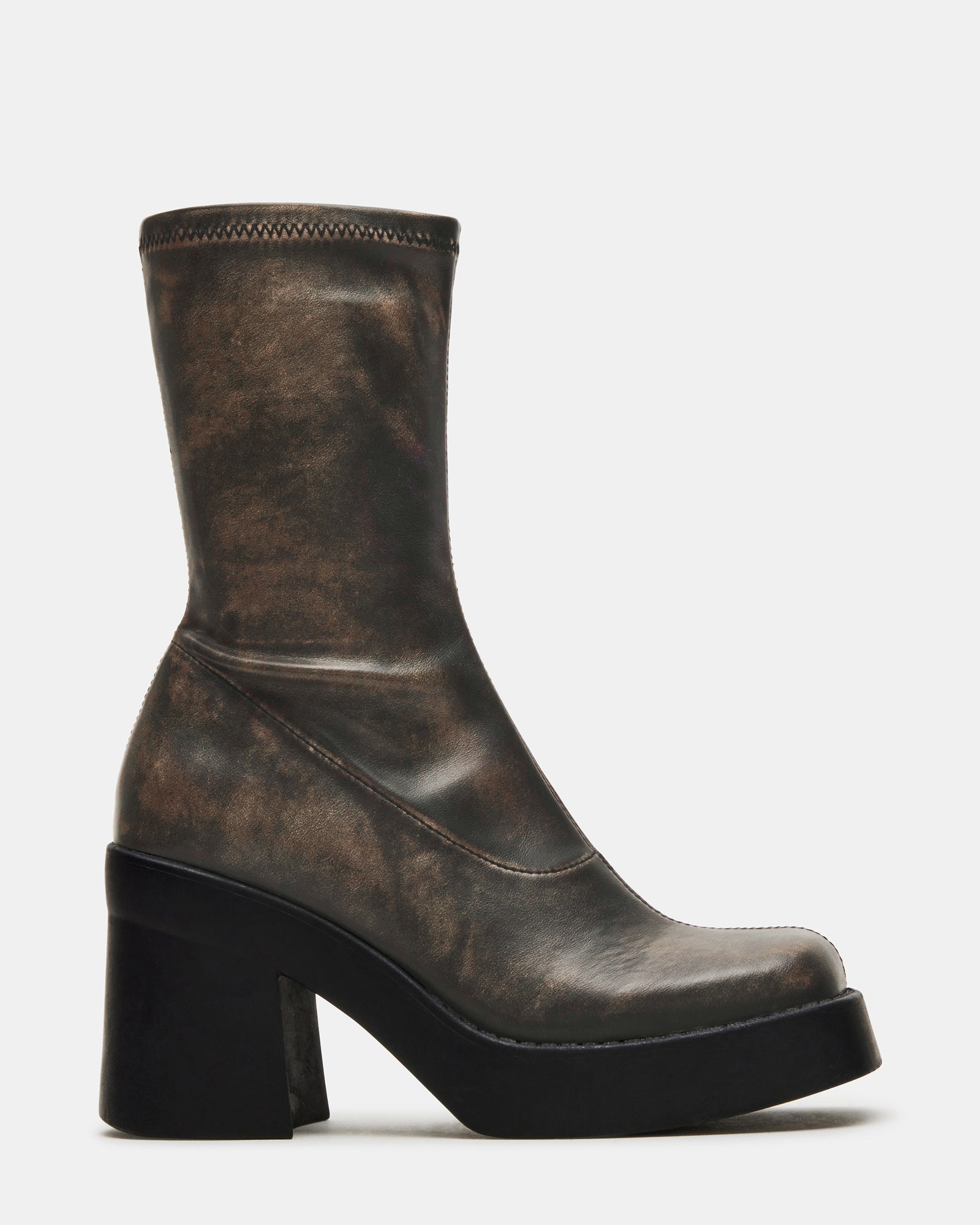 Side view of brown mid calf platform boots showcasing the vegan leather material.