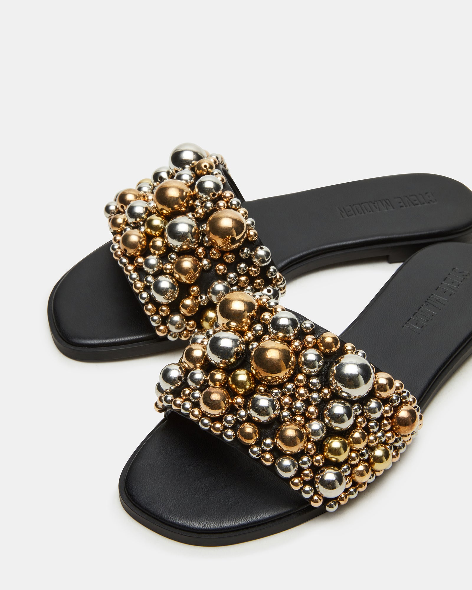 Fashionable KLIO slide sandals with ornament embellishments on a models feet
