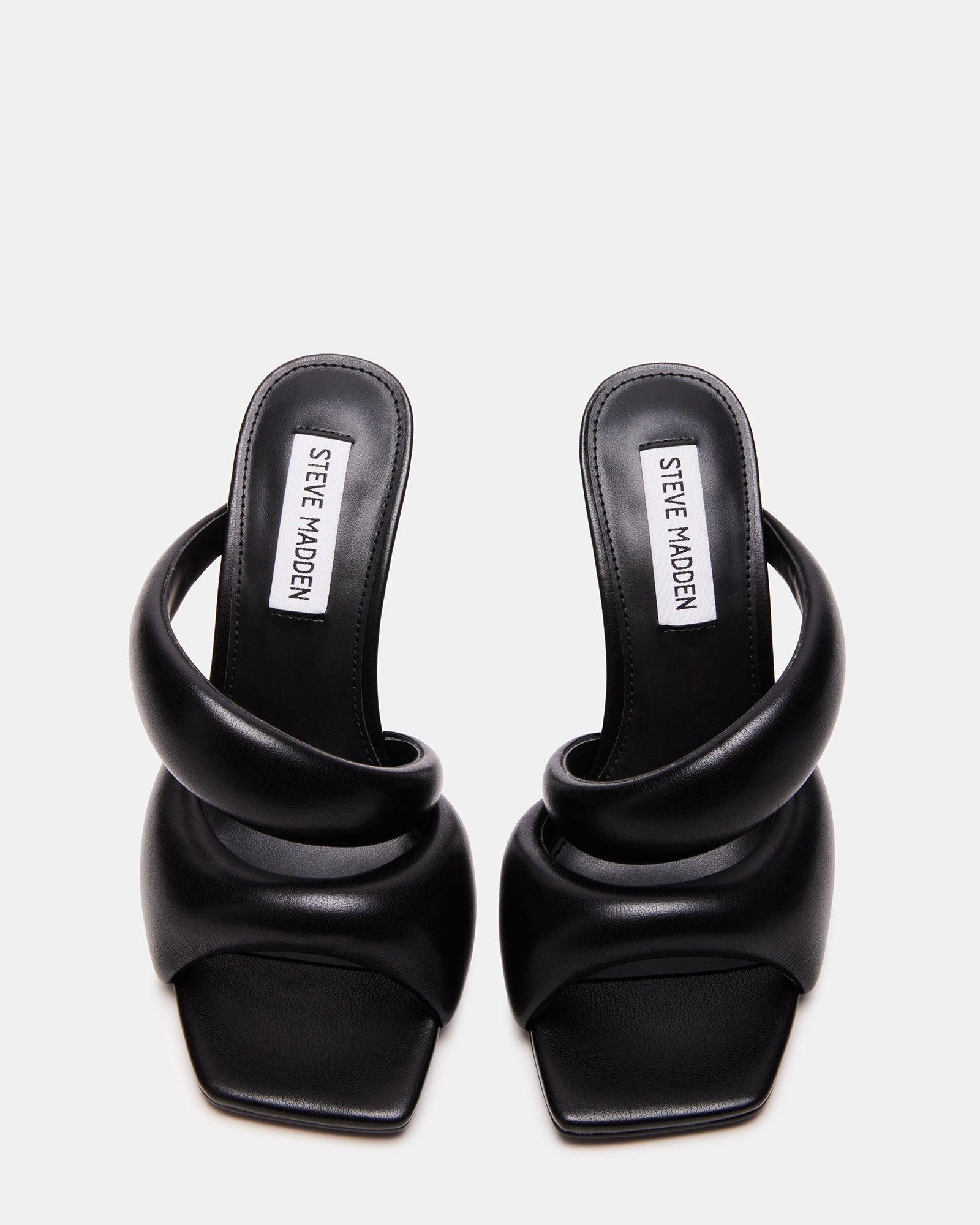 Close-up of the angled heel on KLOSS Black square toe heeled sandals.