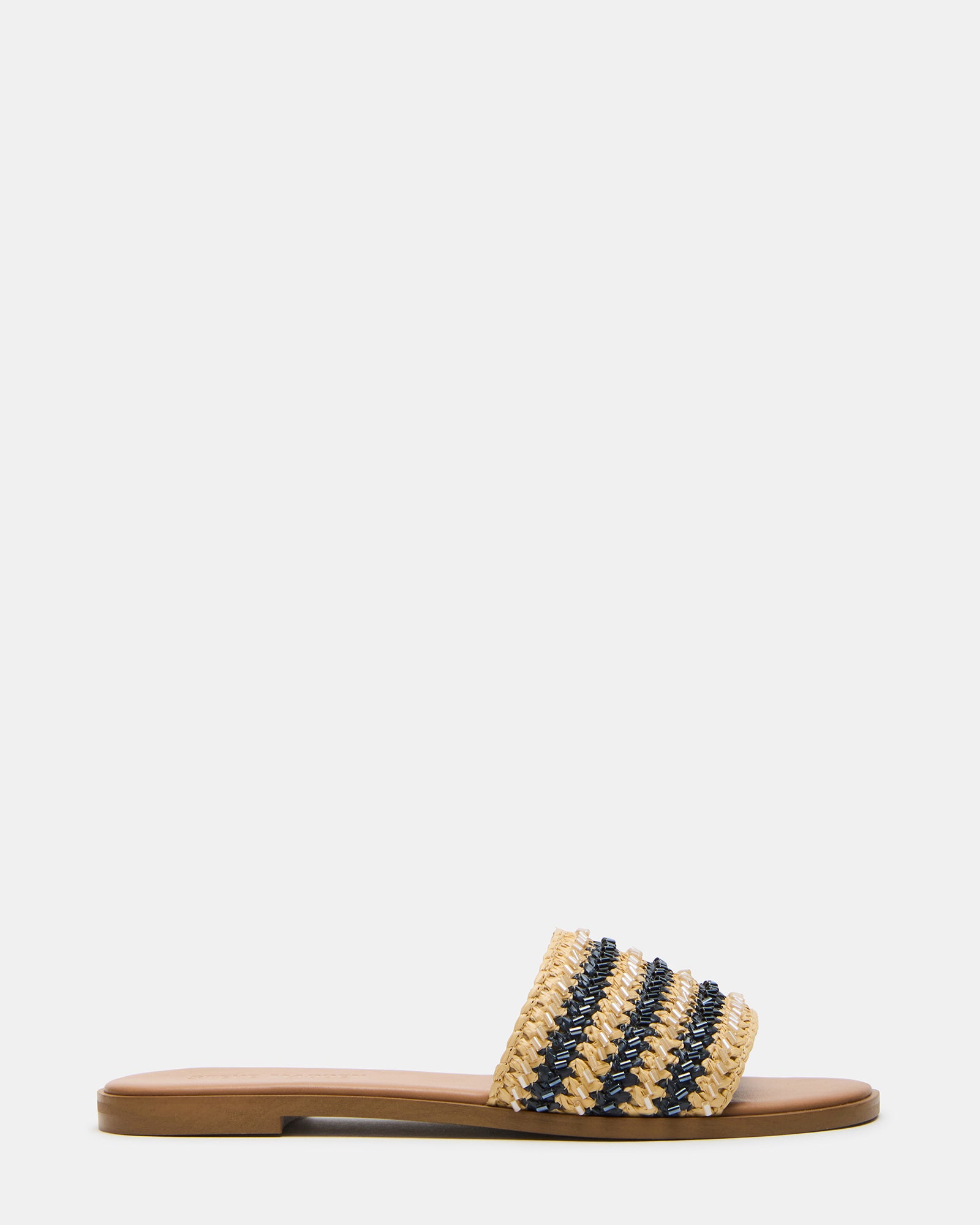 Close-up of the raffia upper on Kooper flat slide sandals in navy multi, resting on a linen cushion