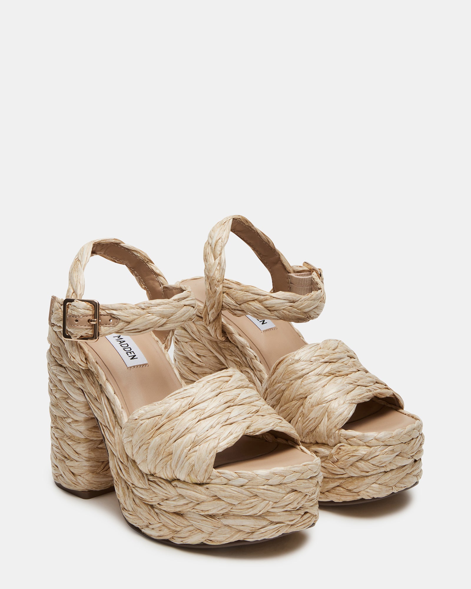 Koral Luxe Raffia Platform Heels styled with a summer dress on a city street.