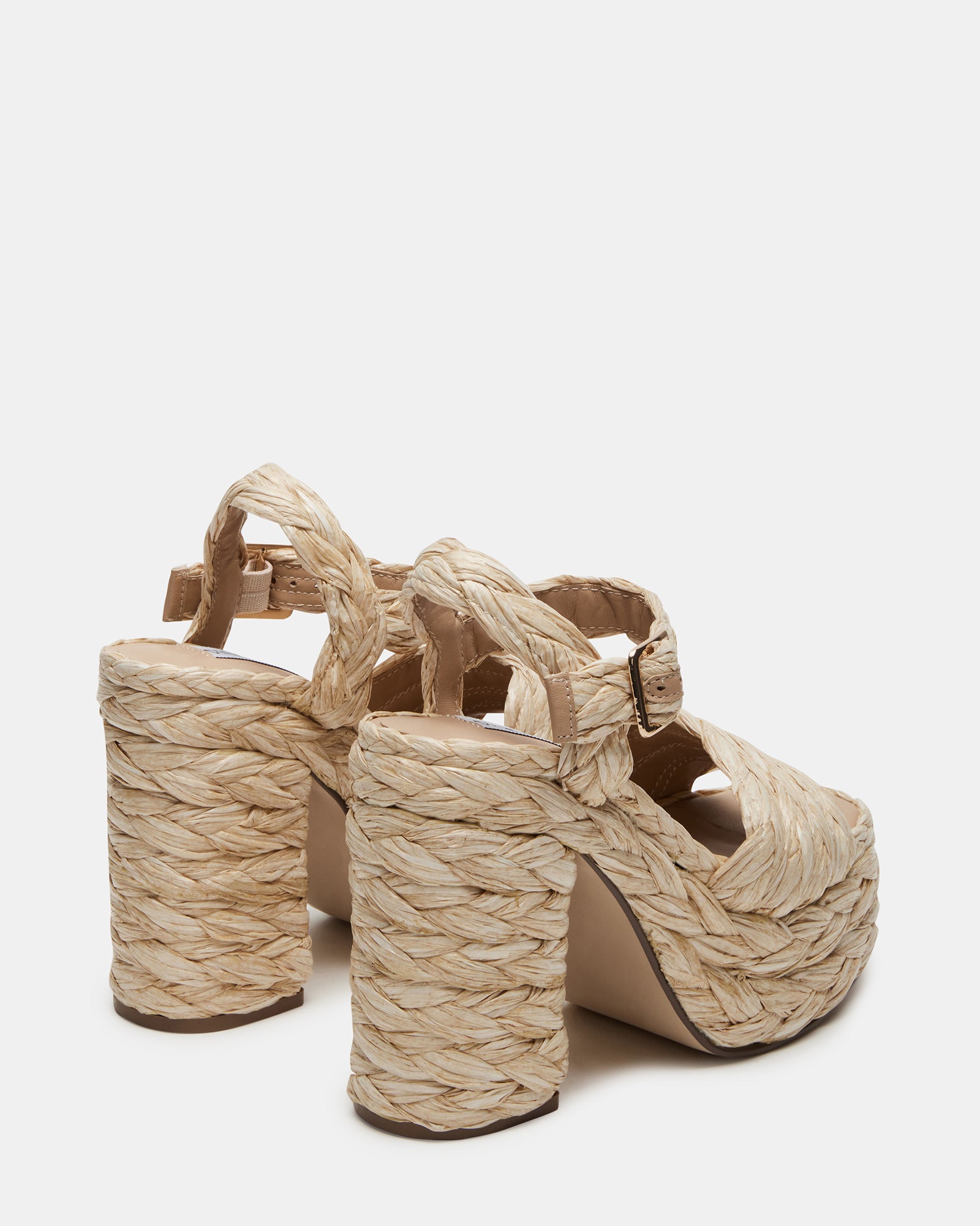 Koral Luxe Raffia Platform Heels styled with a summer dress on a city street.