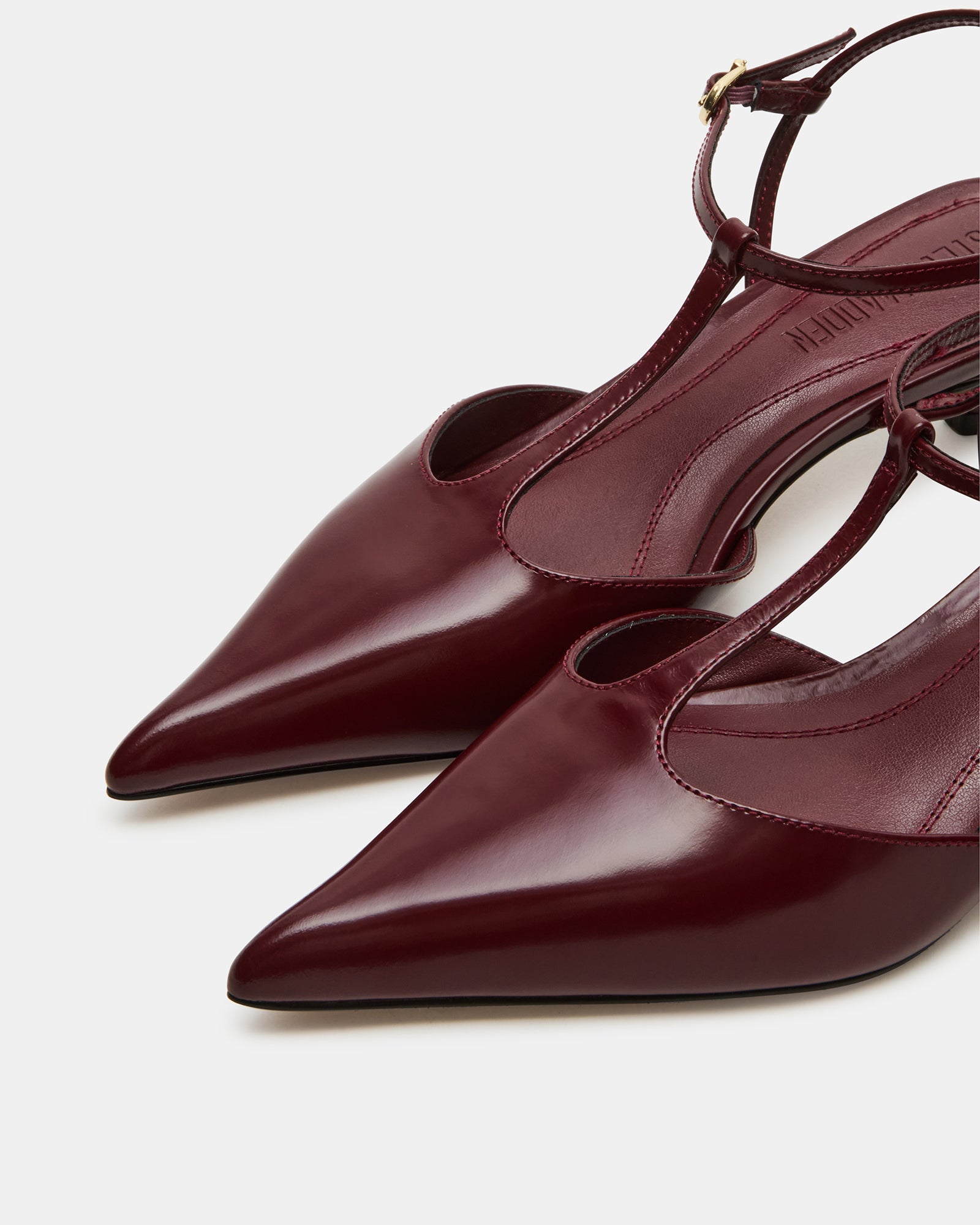 Close-up of white kitten heels showing sleek pointed toe design