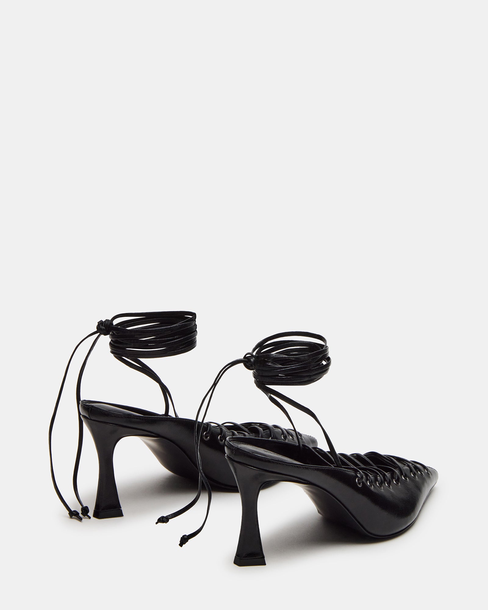 Pointed toe nude strappy heels paired with a cocktail dress.