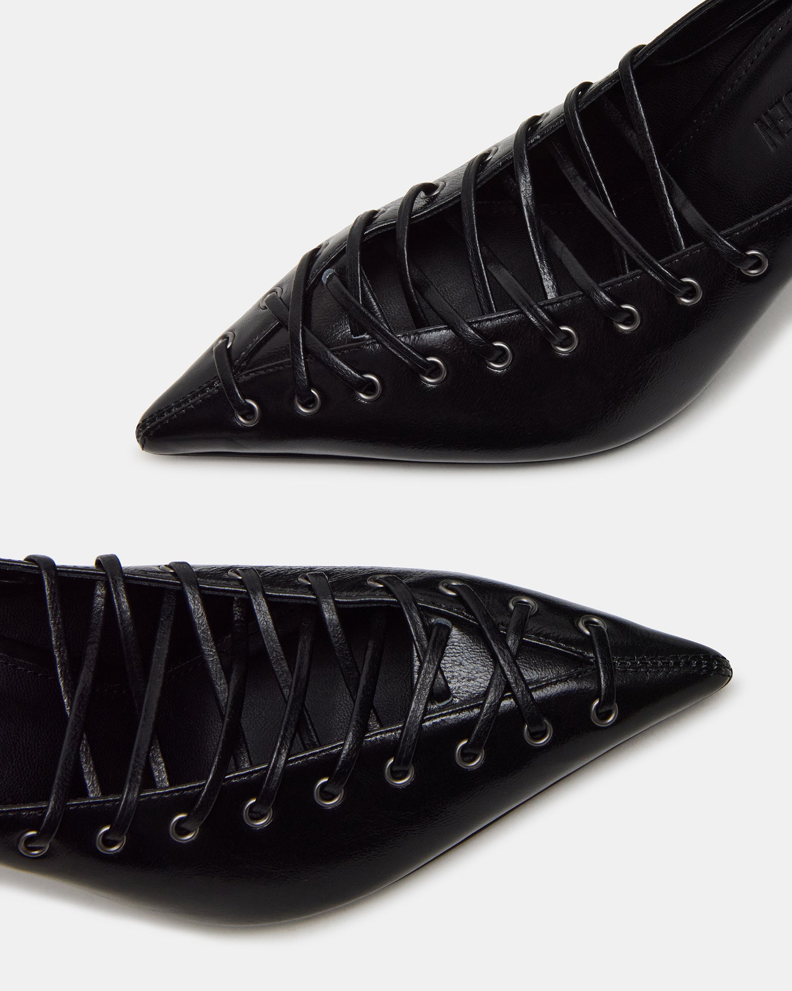 Lucelle black strappy heels side view, showcasing leather texture.