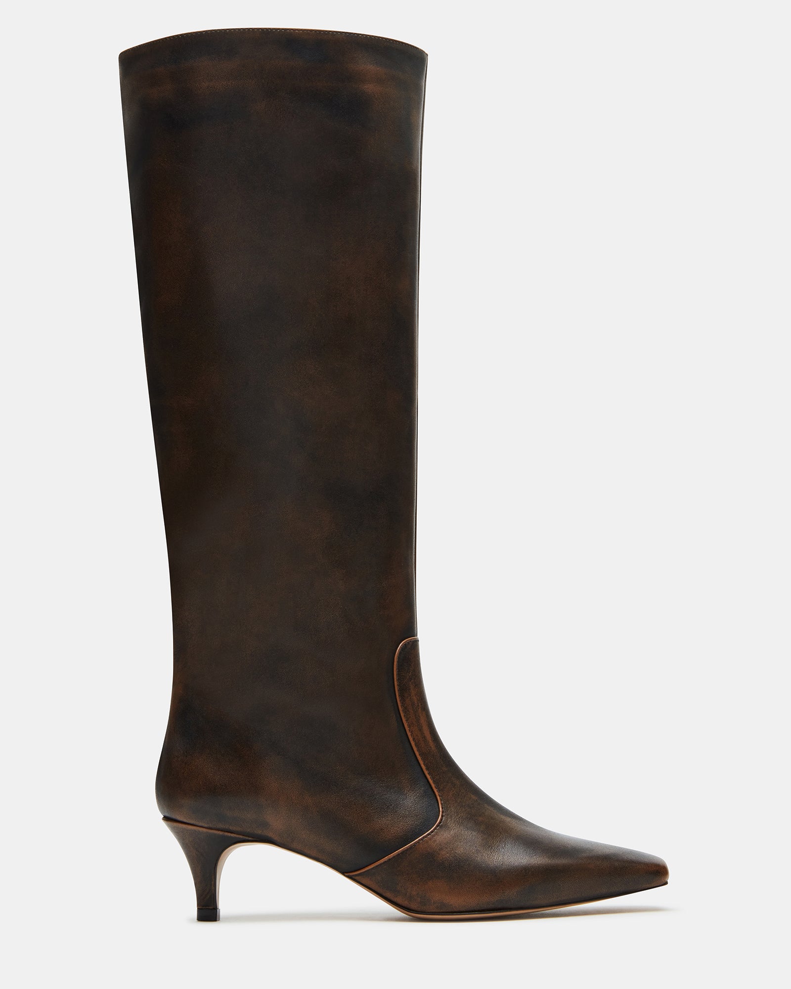 Side view of distressed brown knee-high boots with kitten heel, styled with jeans