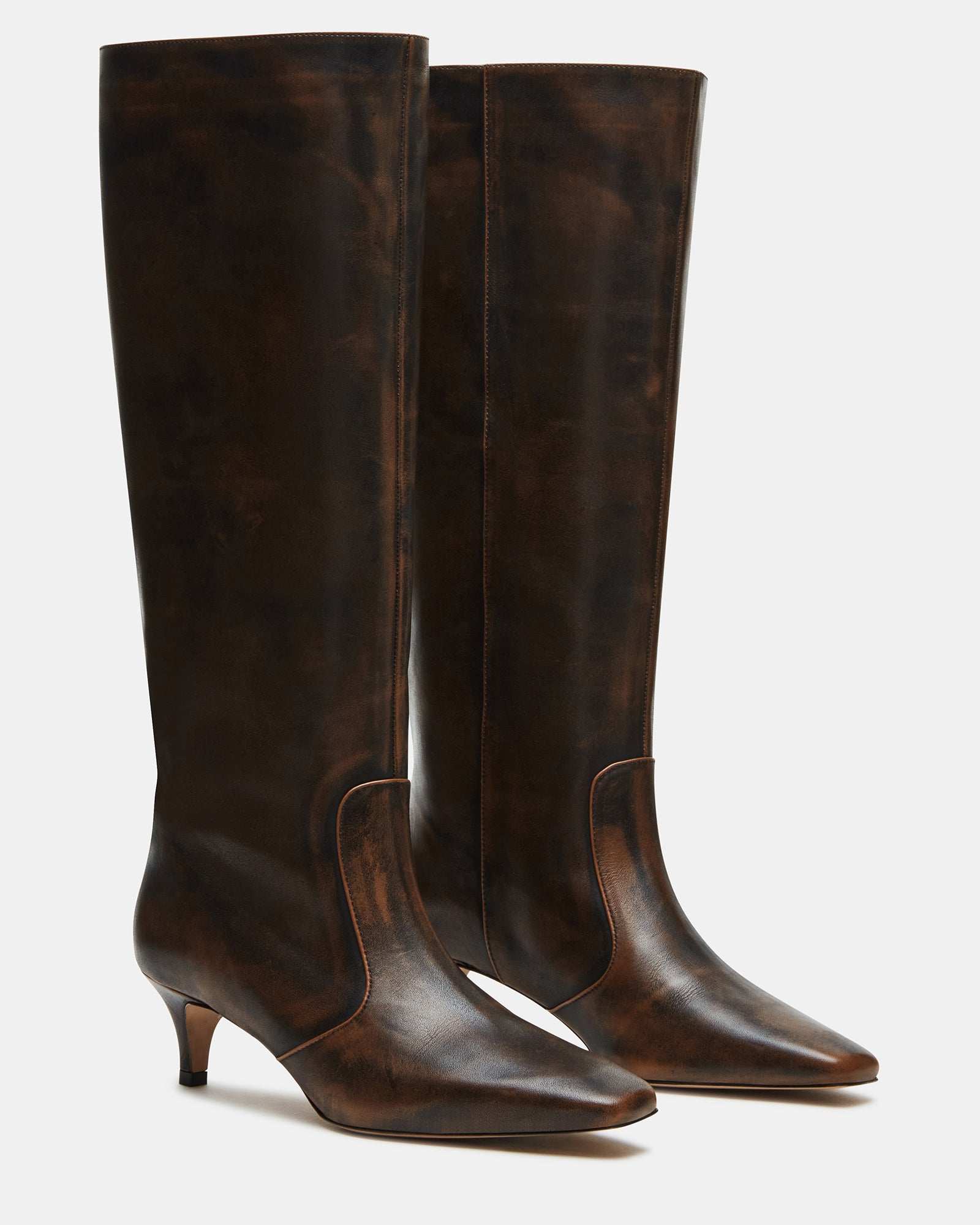 Model wearing brown distressed boots with a dress for a night out