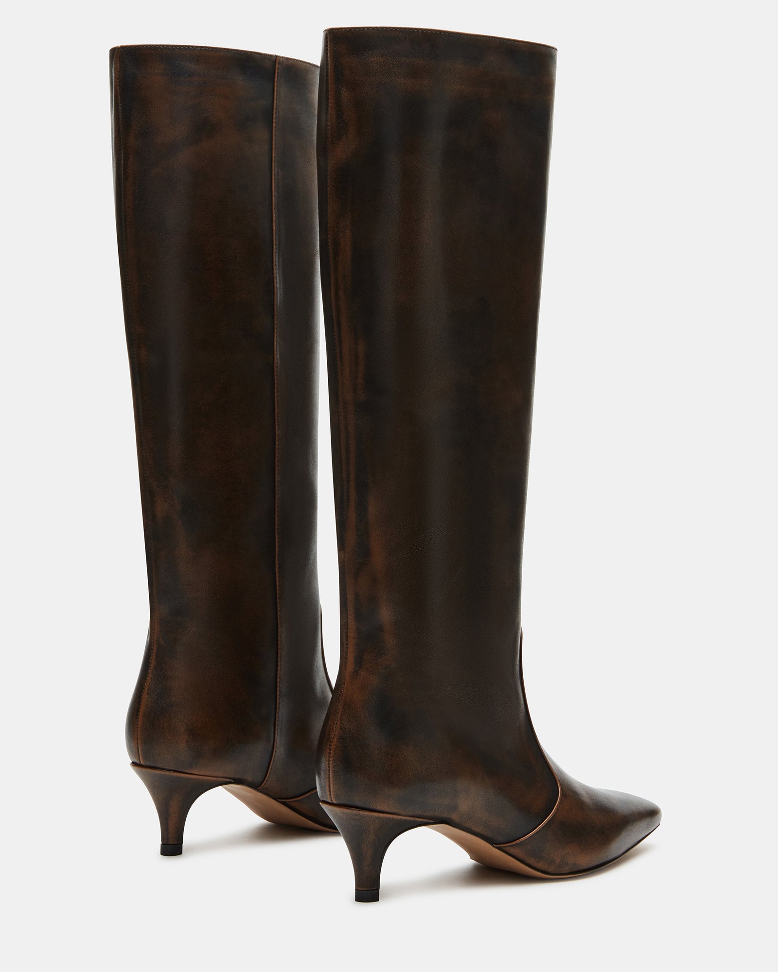 Model wearing brown distressed boots with a dress for a night out