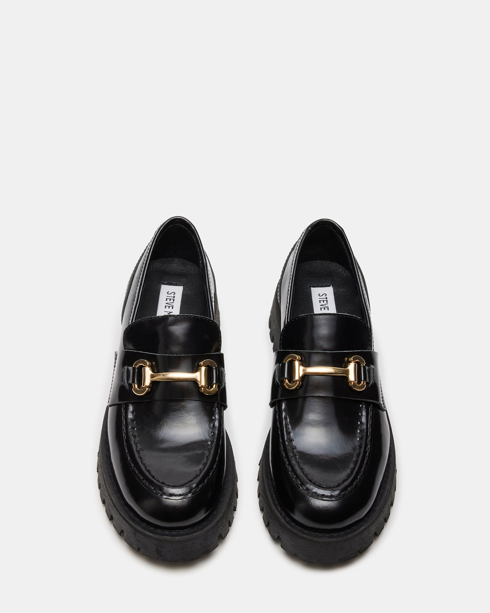 Front angle of black leather loafers highlighting the stylish design and heel height