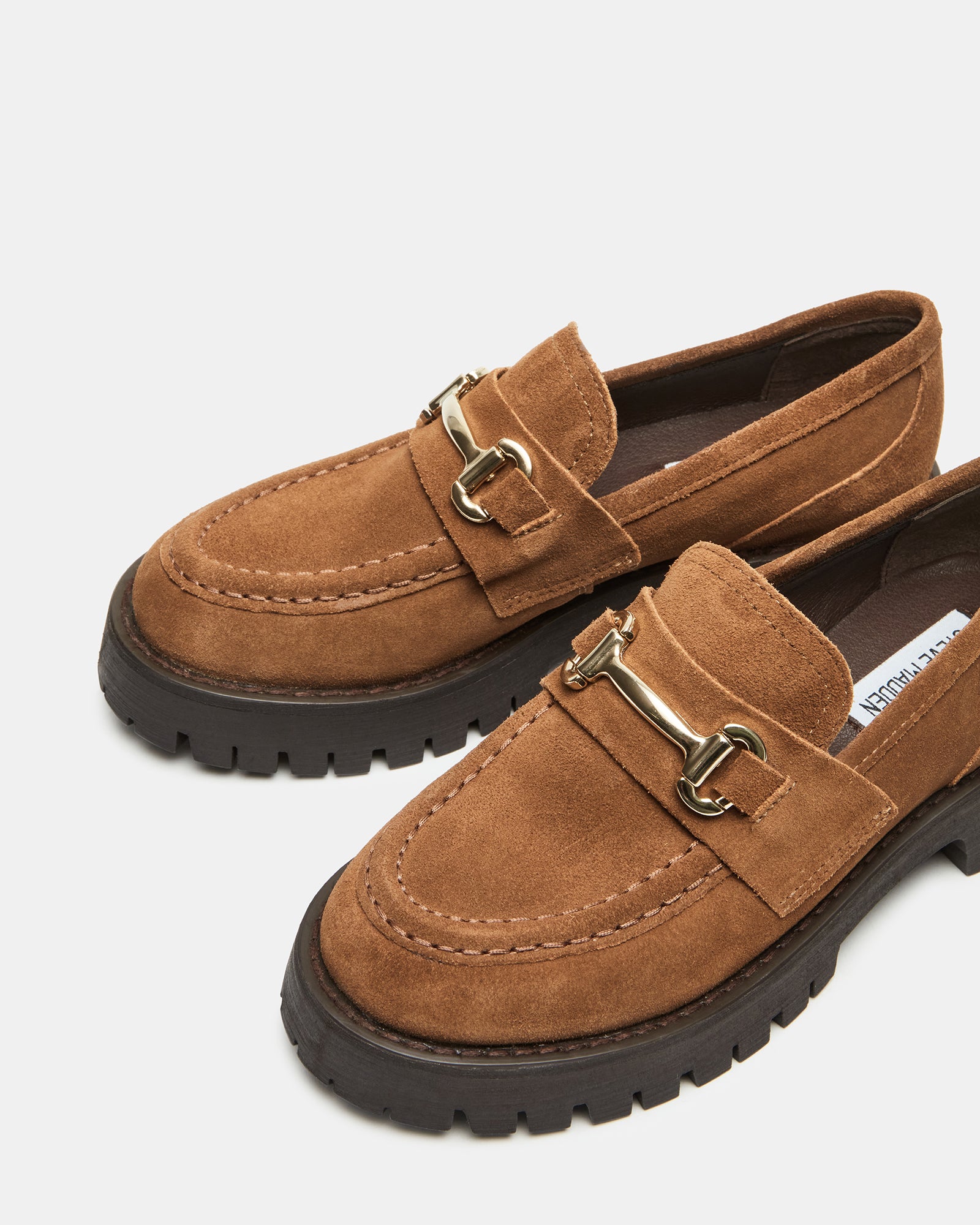 Close-up of LANDO suede platform loafers highlighting the horsebit detail.