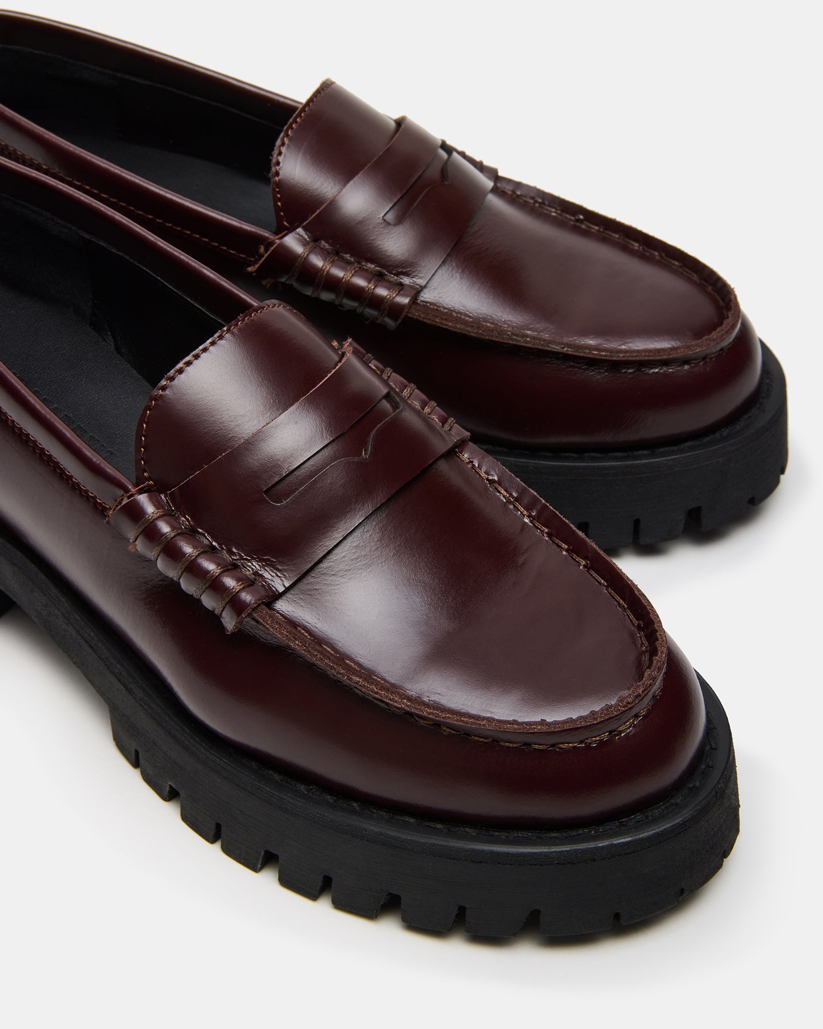 Close-up of Prada-inspired loafers featuring a sturdy sole and classic design