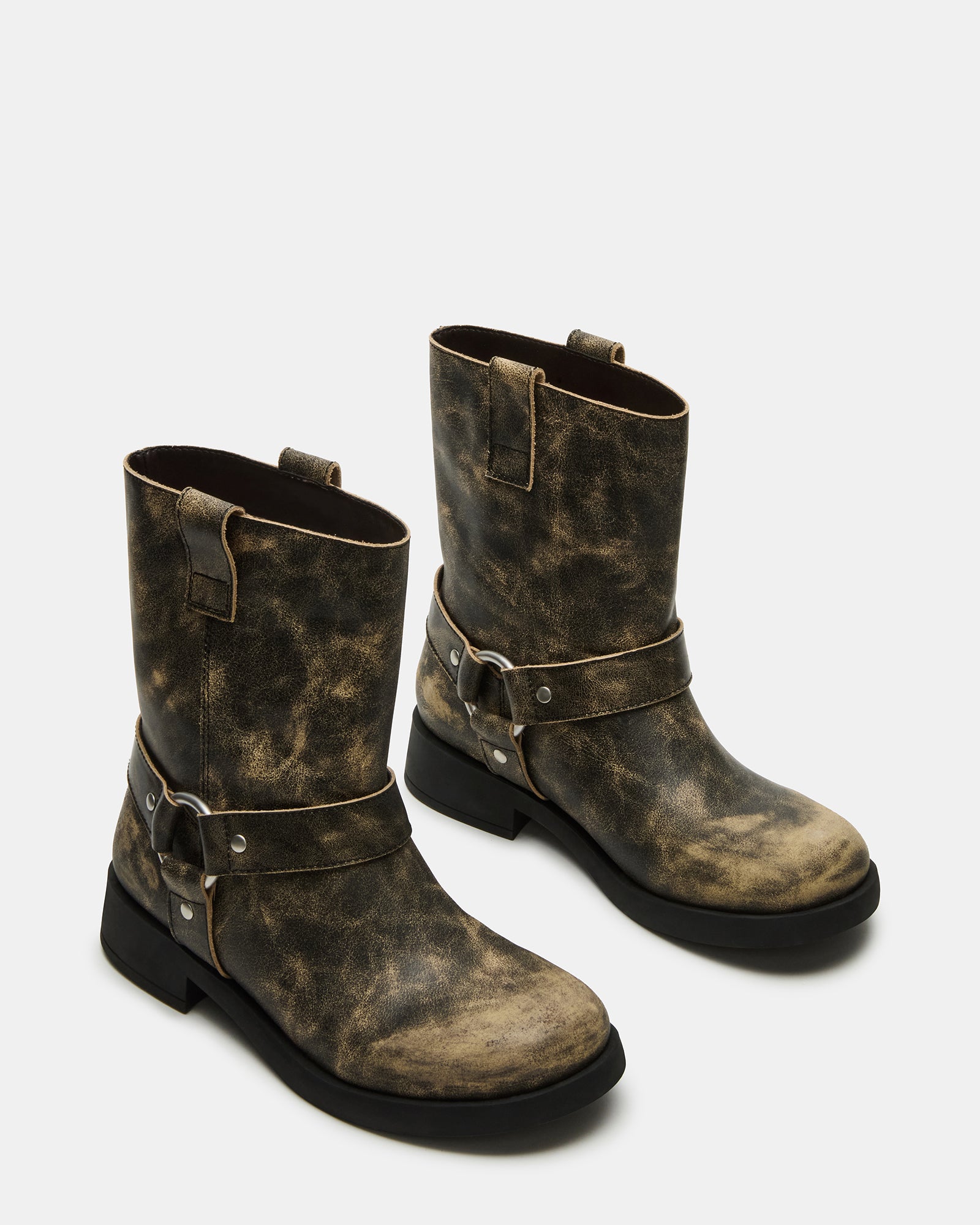 Close-up of black leather boots featuring moto detailing
