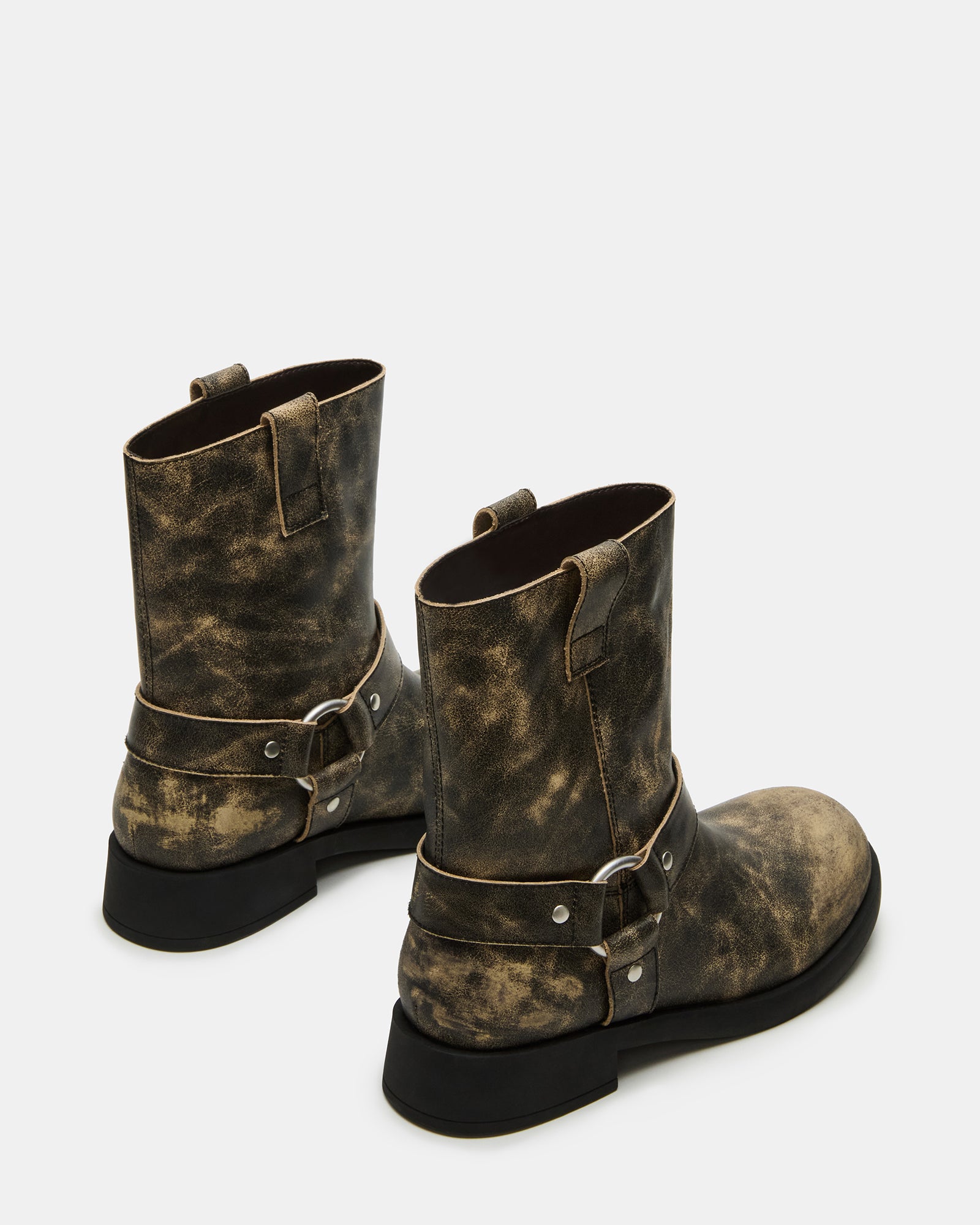 Close-up of black leather boots featuring moto detailing