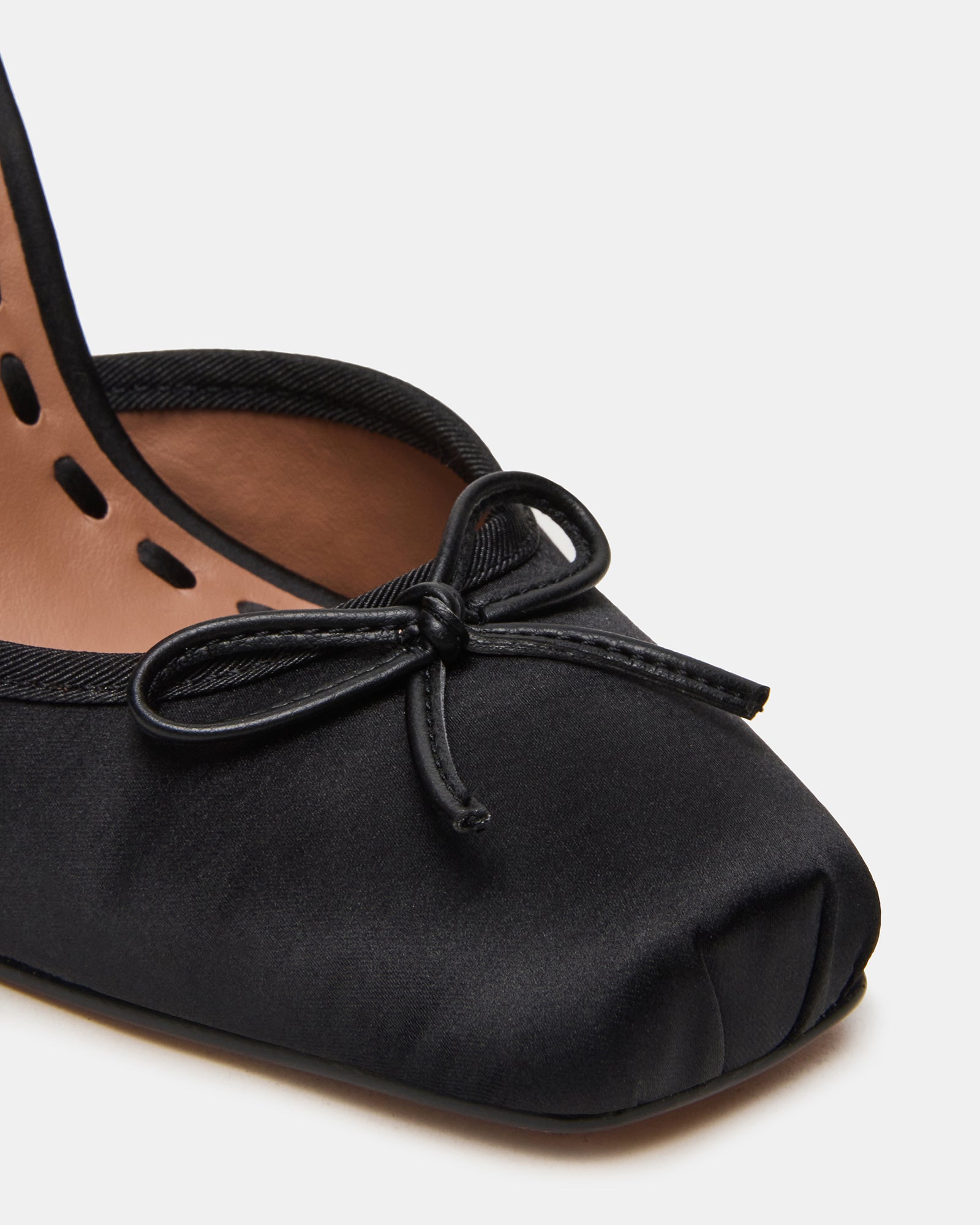 Close-up of lace-up detail on black satin shoes for a secure fit.