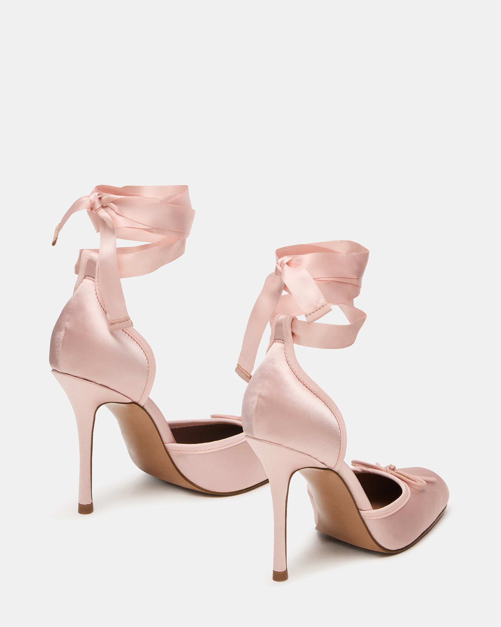 Side angle of lace-up heels in pink wrapped around ankle