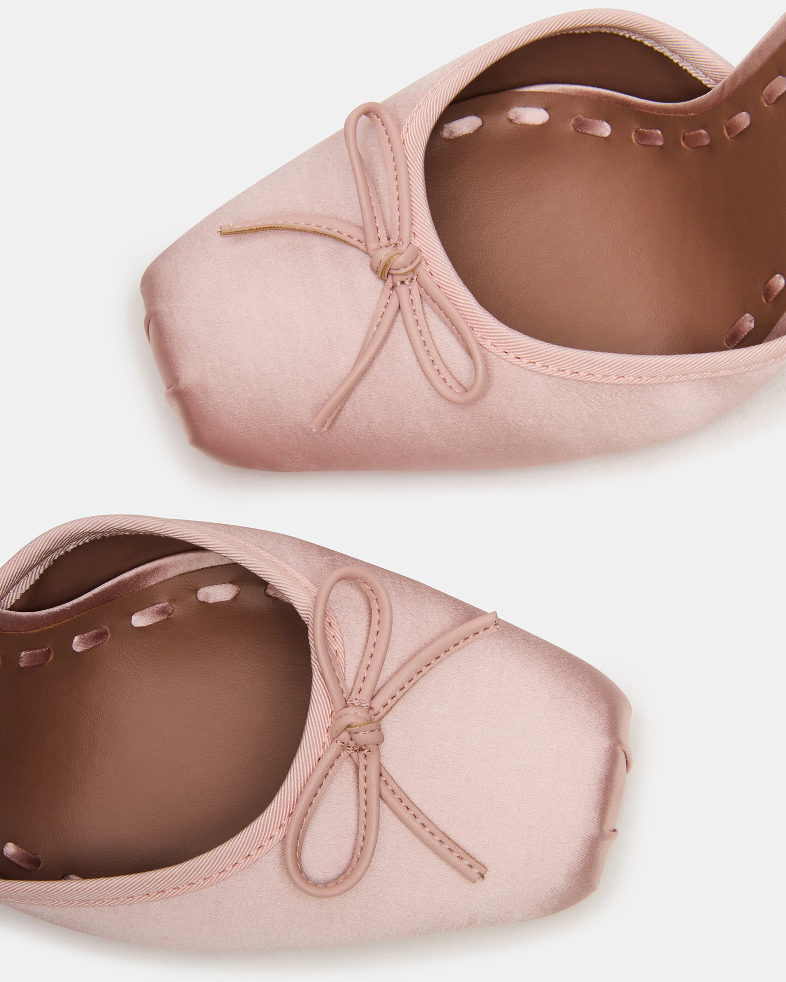 Front view of light pink high heel shoes with satin texture