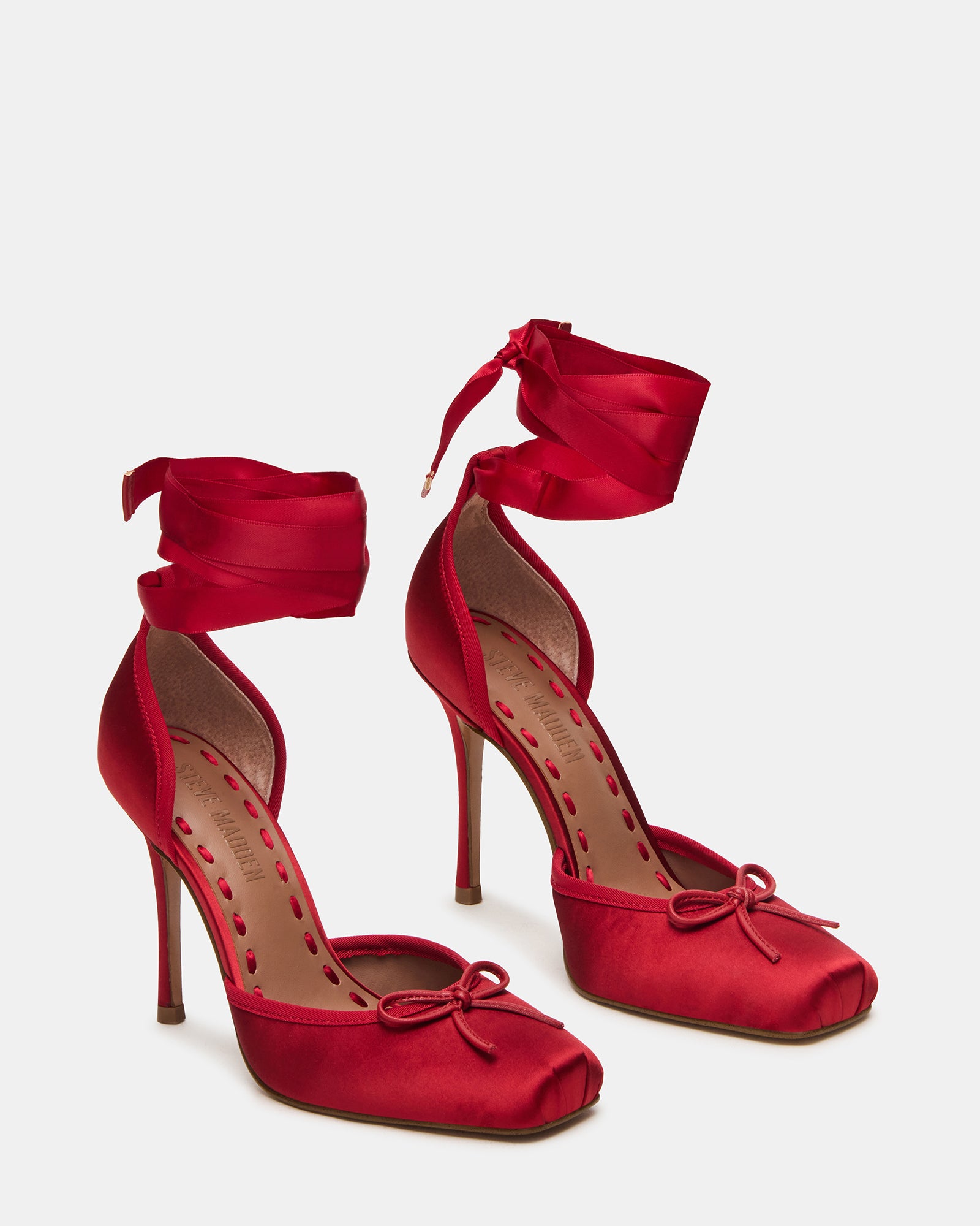 Side view of the block heel pumps, highlighting the intricate lace-up detail.